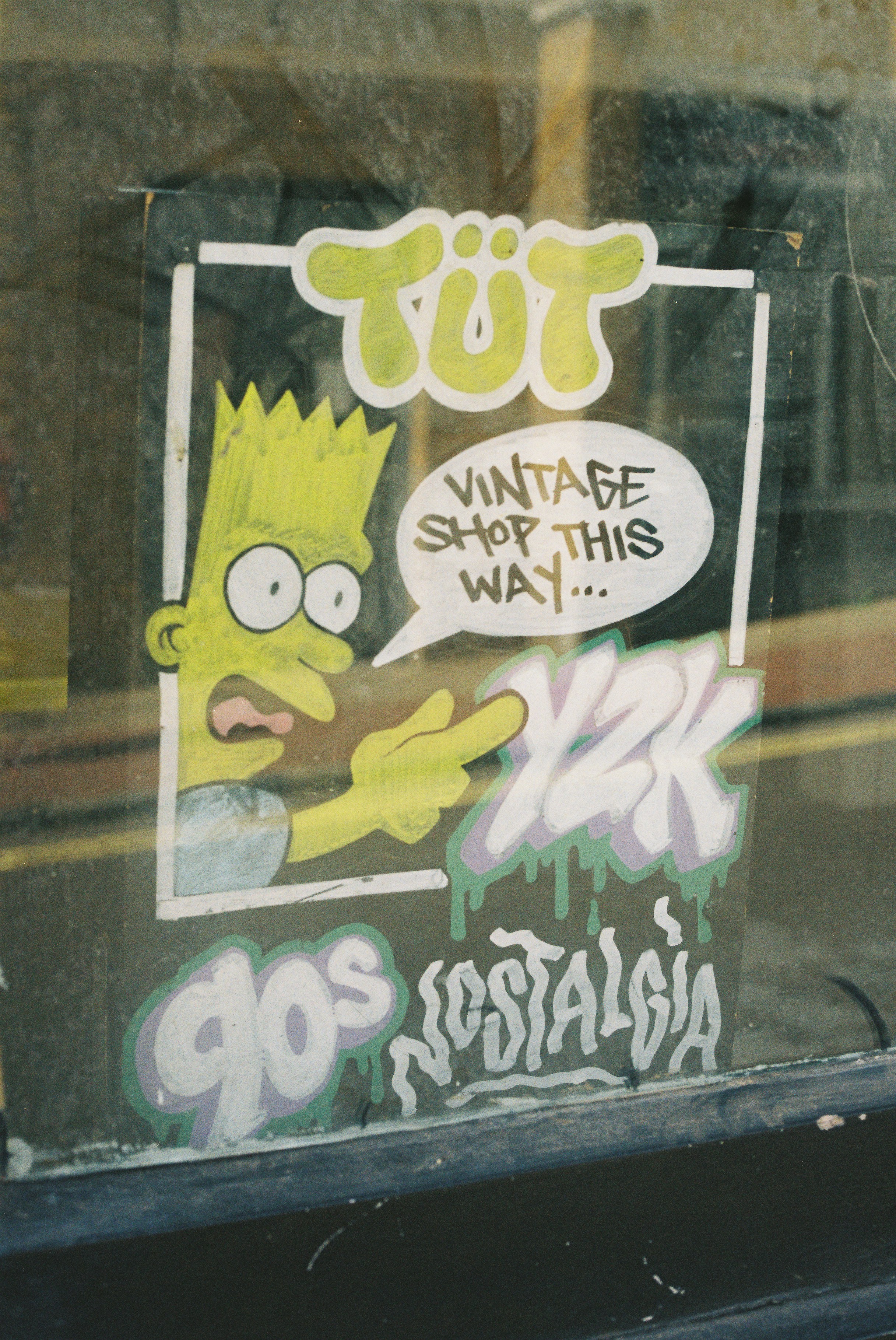 Bart simpson sticker advertises a vintage shop with 90s nostalgia.