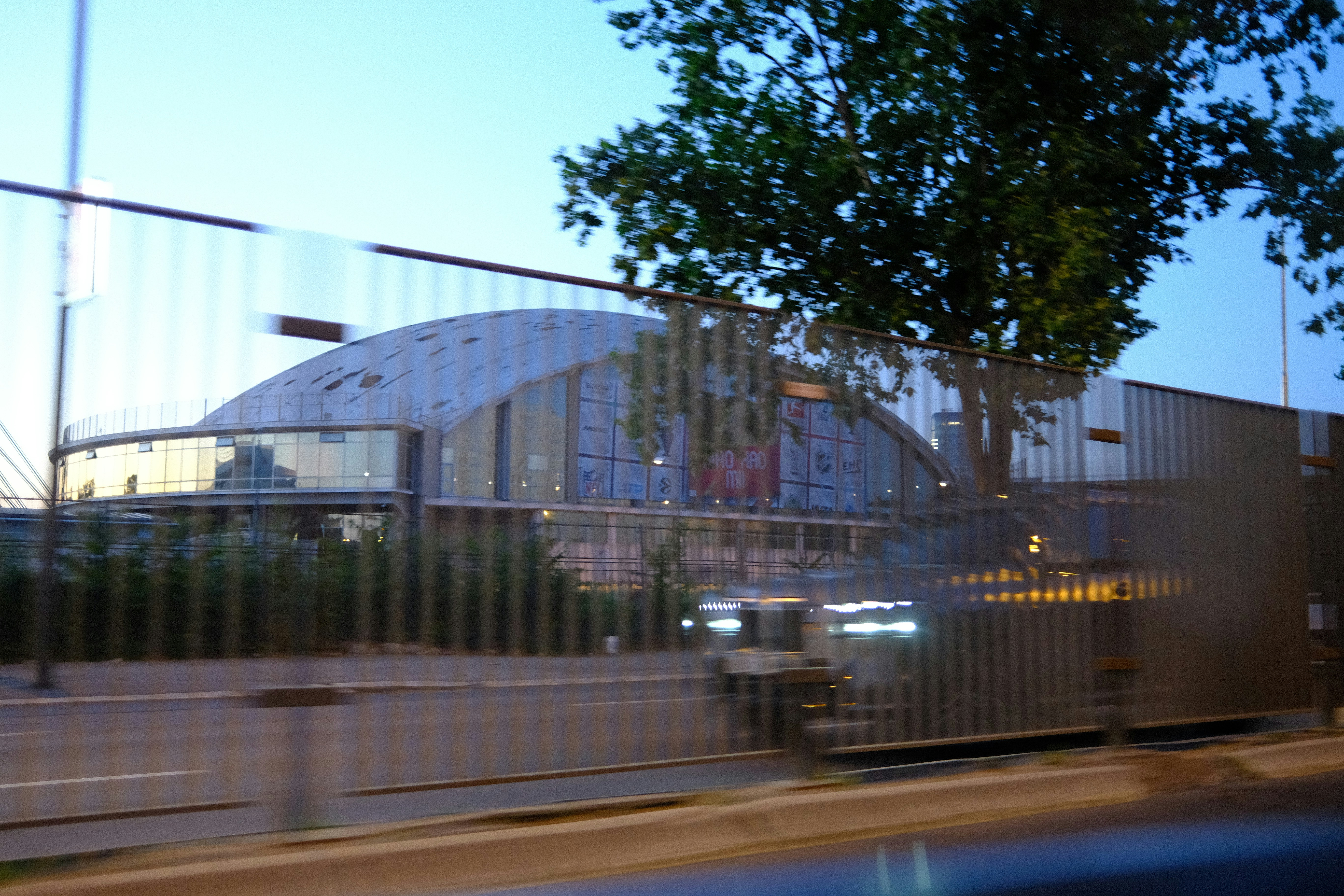 Modern architectural building with a domed roof and fence.