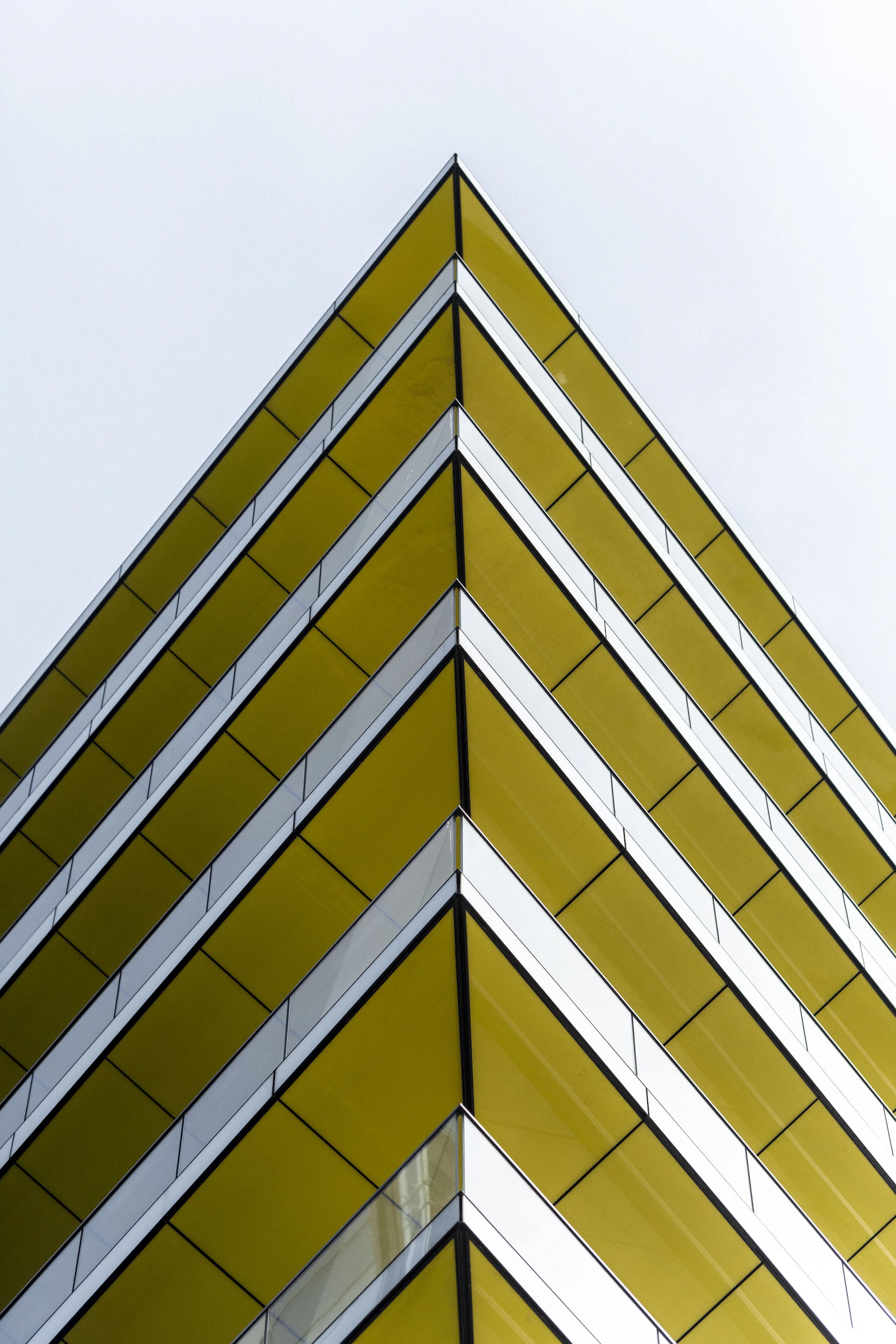 Geometric corner of a modern building with yellow facade
