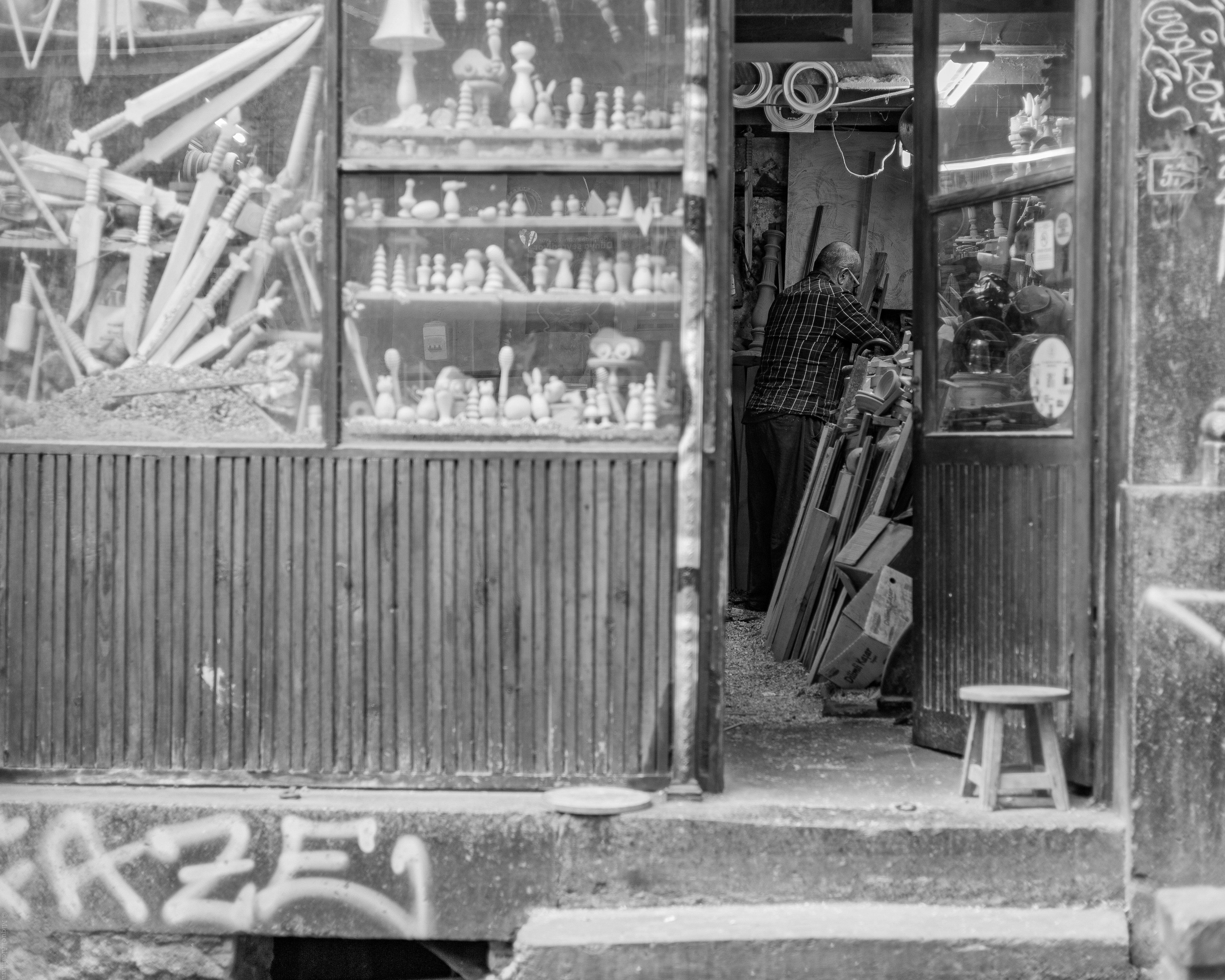 Shop entrance with a person inside and various items displayed.