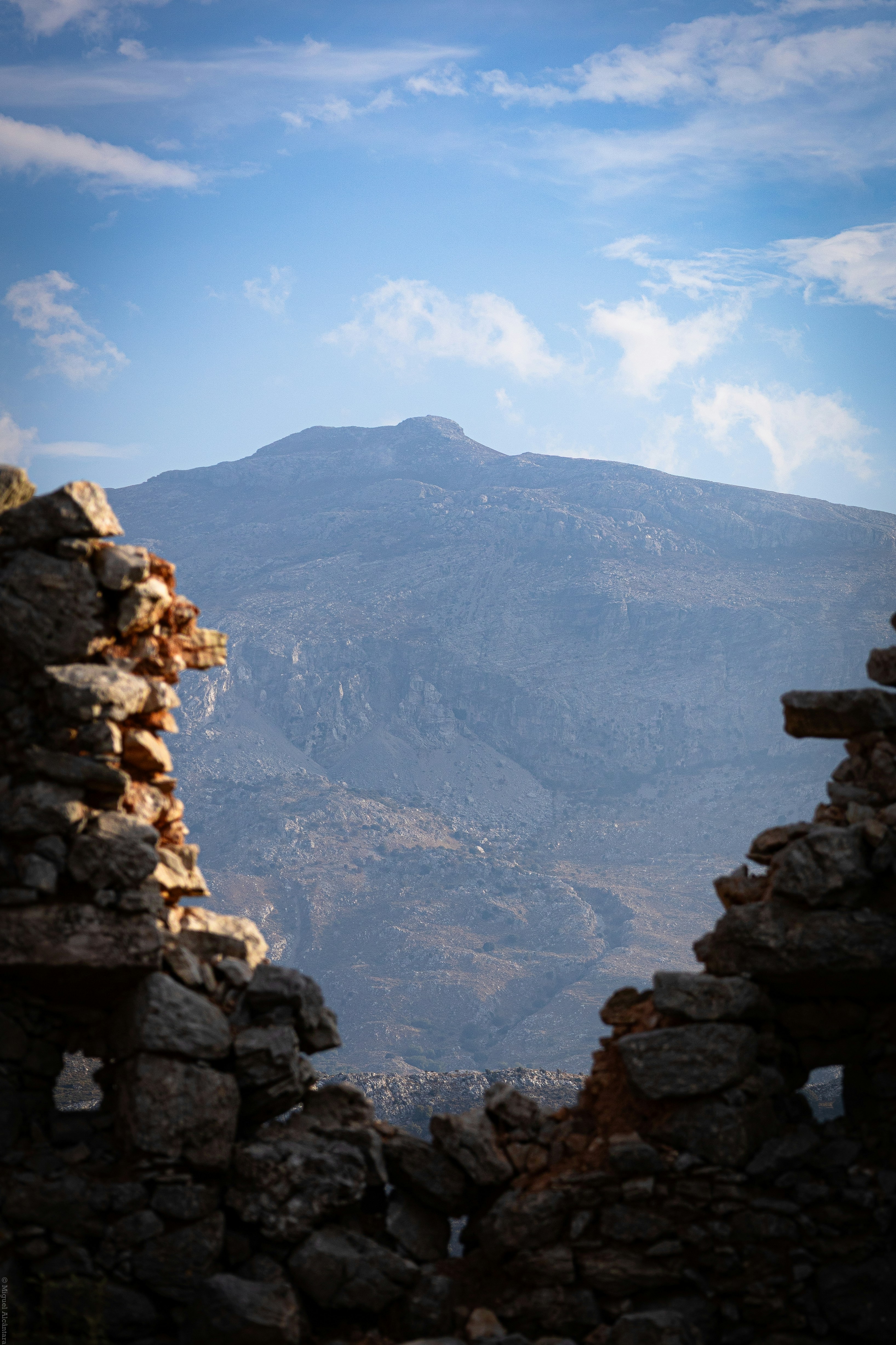 Mountain view framed by ancient stone ruins.