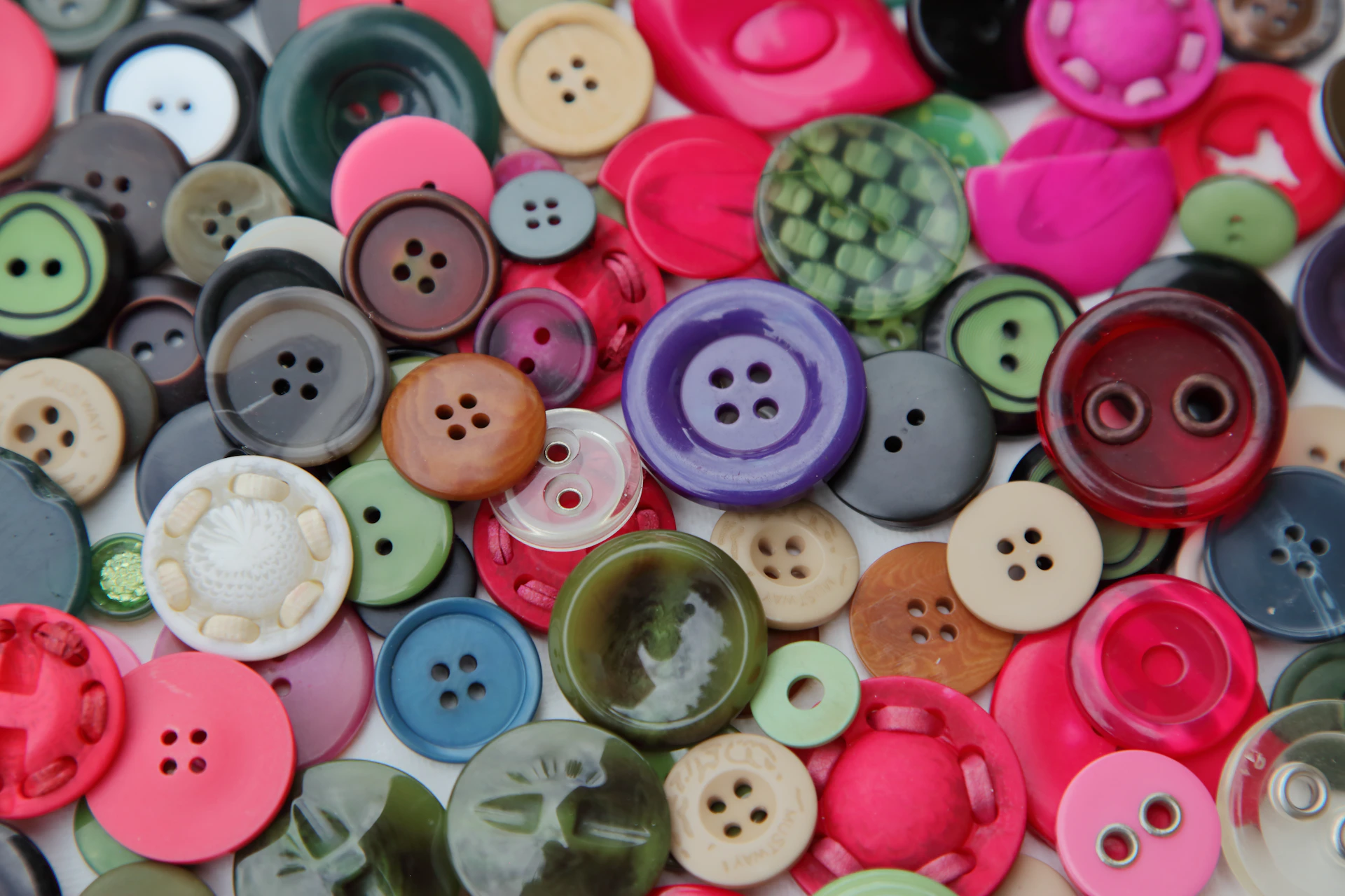 A vibrant assortment of colorful buttons scattered across a surface