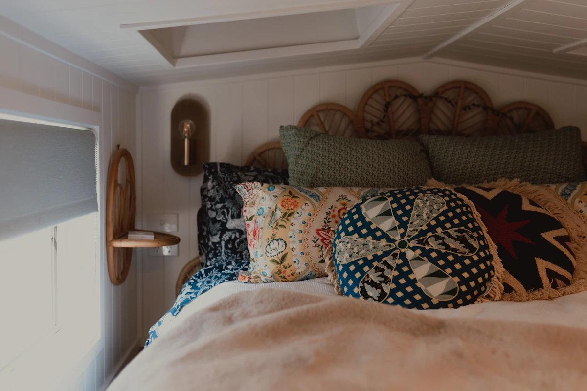 Cozy bedroom with decorative pillows and a wicker headboard