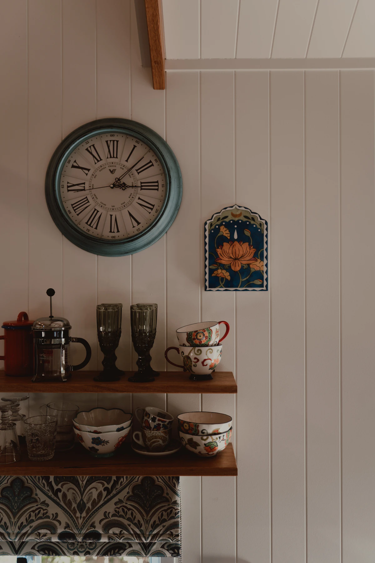 Metal rail with hanging utensils in a small cozy kitchen