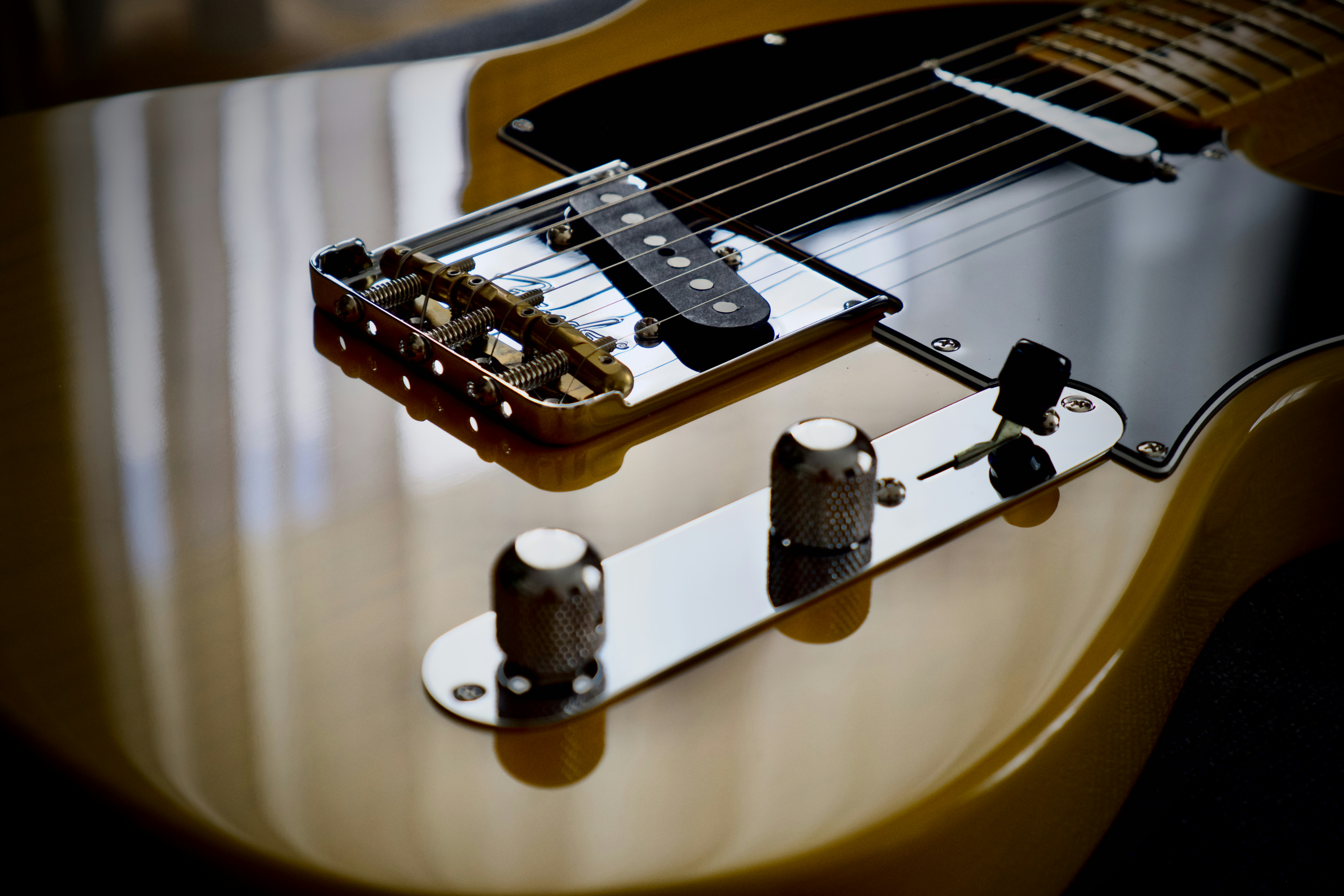 Bodi gitar listrik dengan jembatan, pickup, dan kenop kontrol.