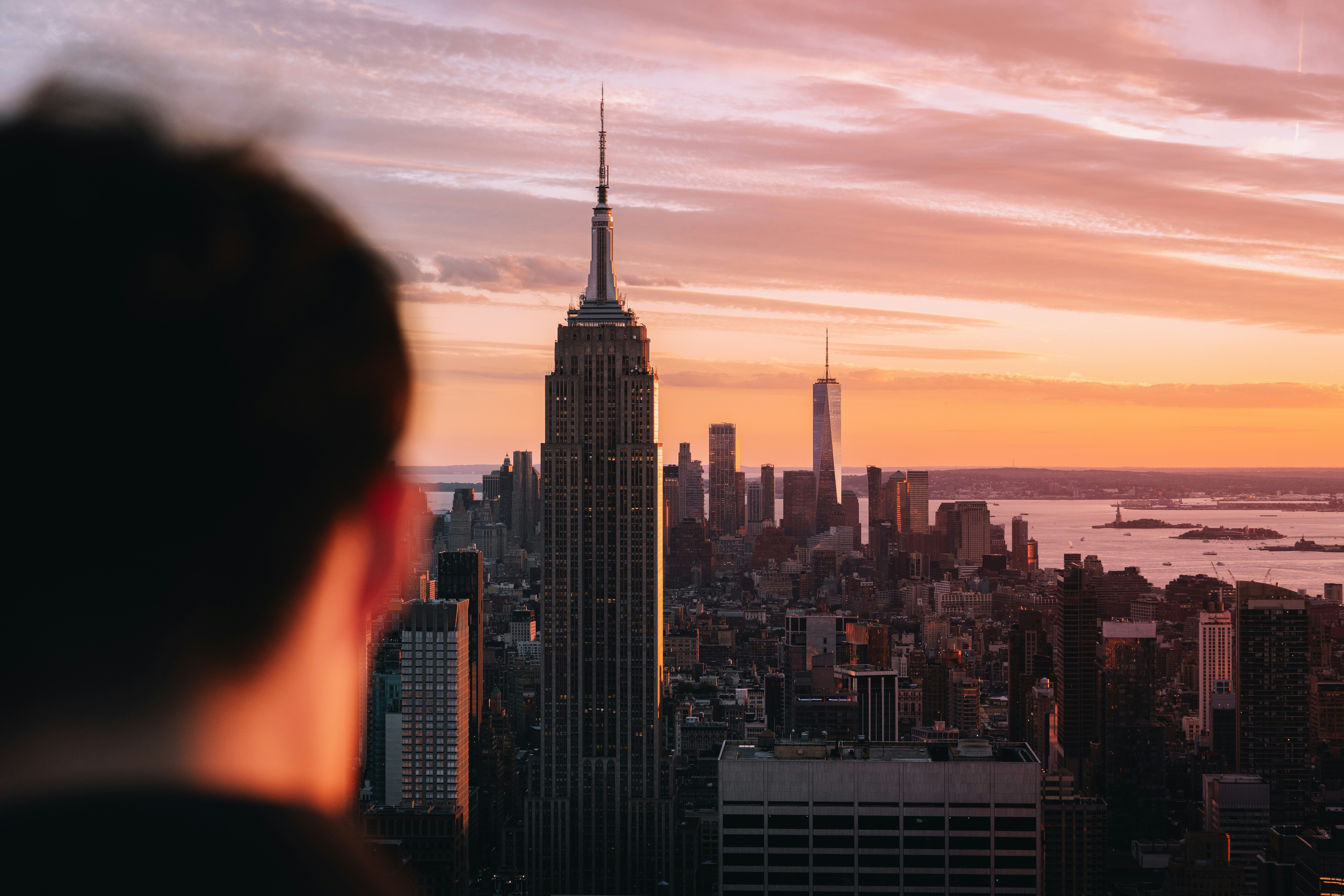 Person views new york city skyline at vibrant sunset. - 相关推荐