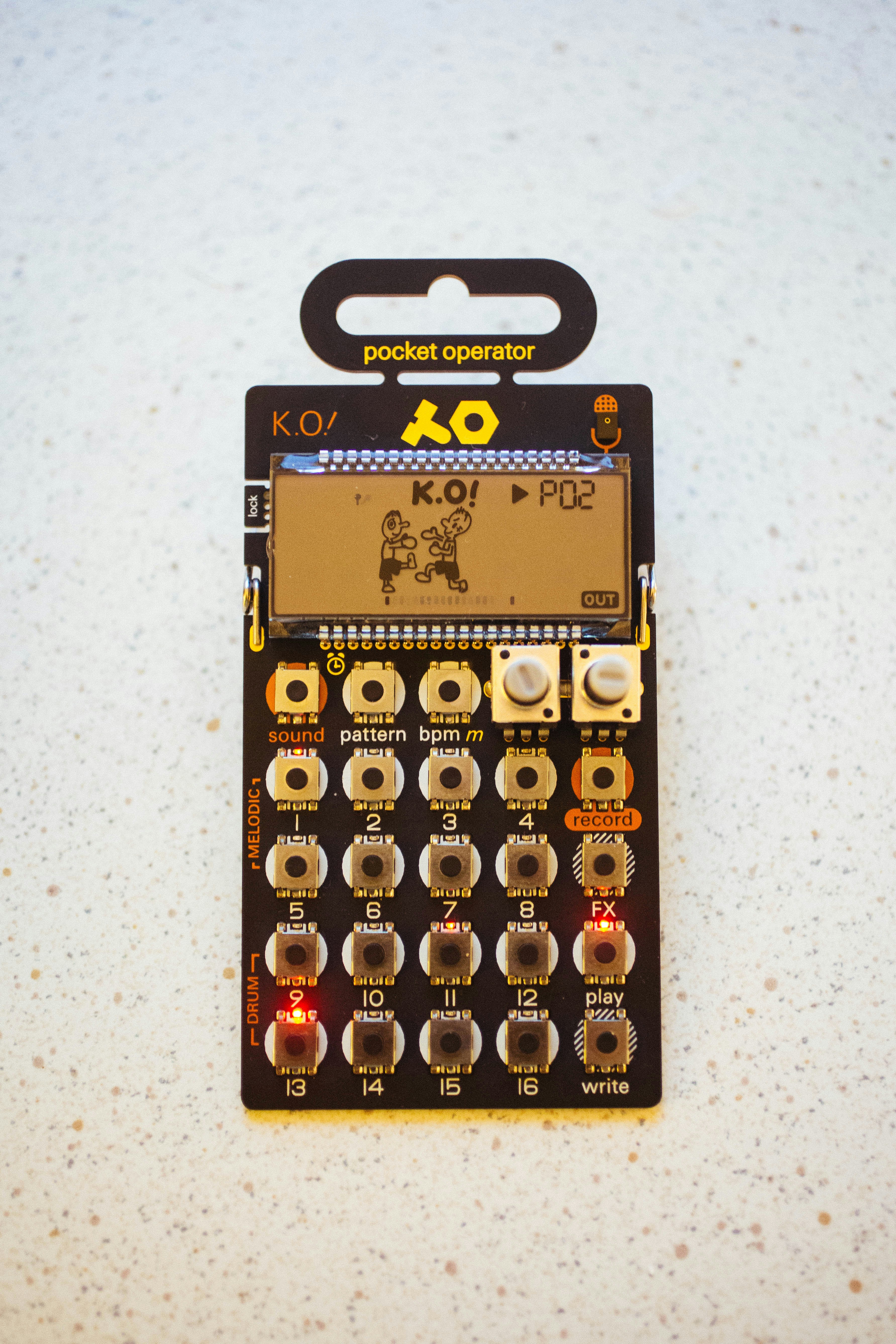 Black pocket operator k.o. synthesizer displaying "k.o!" on screen.