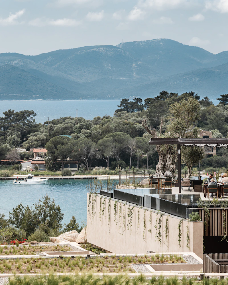The hotel building above a coastal bay