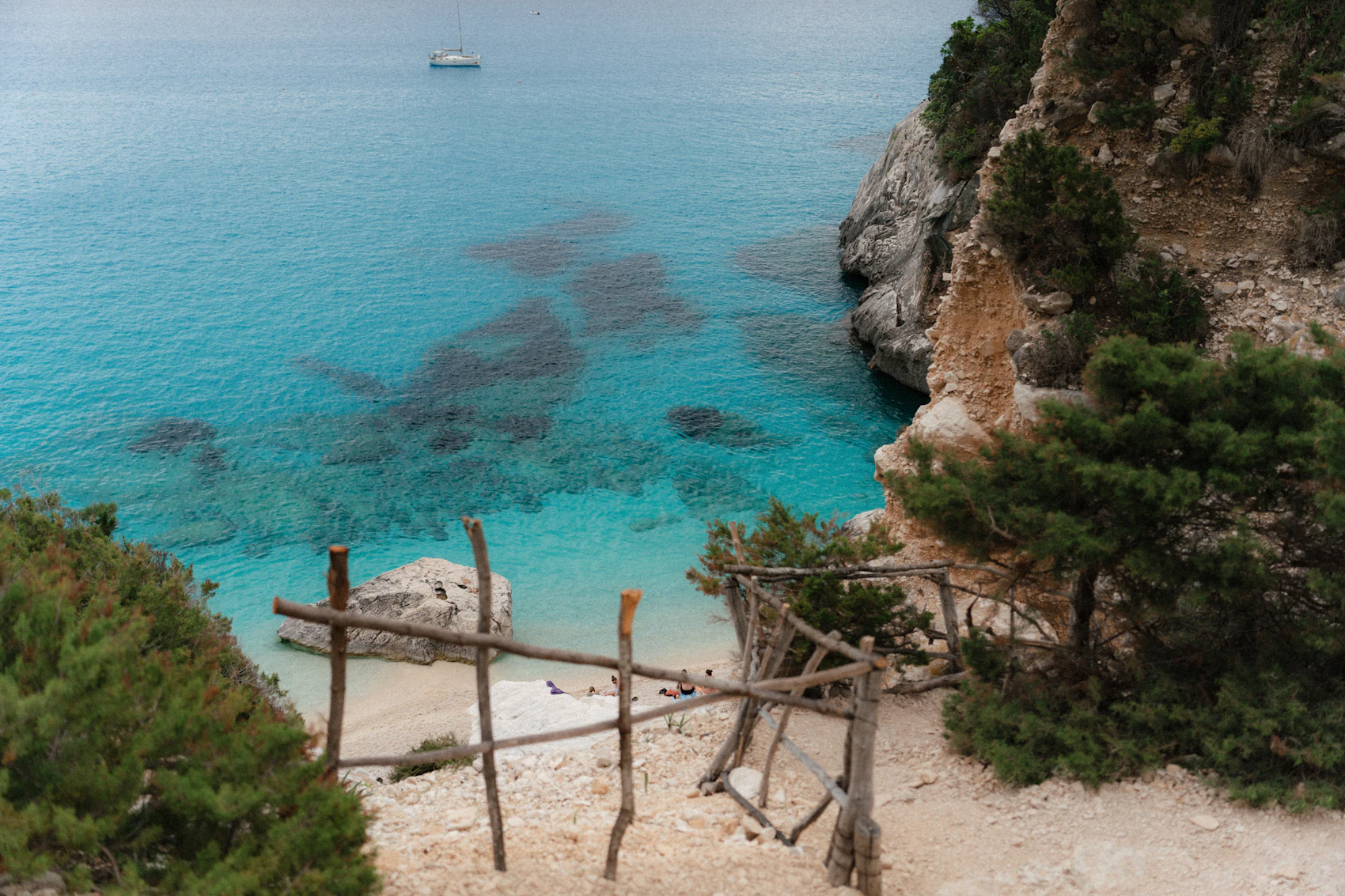 A secluded rocky cove and clear turquoise water in Sardinia