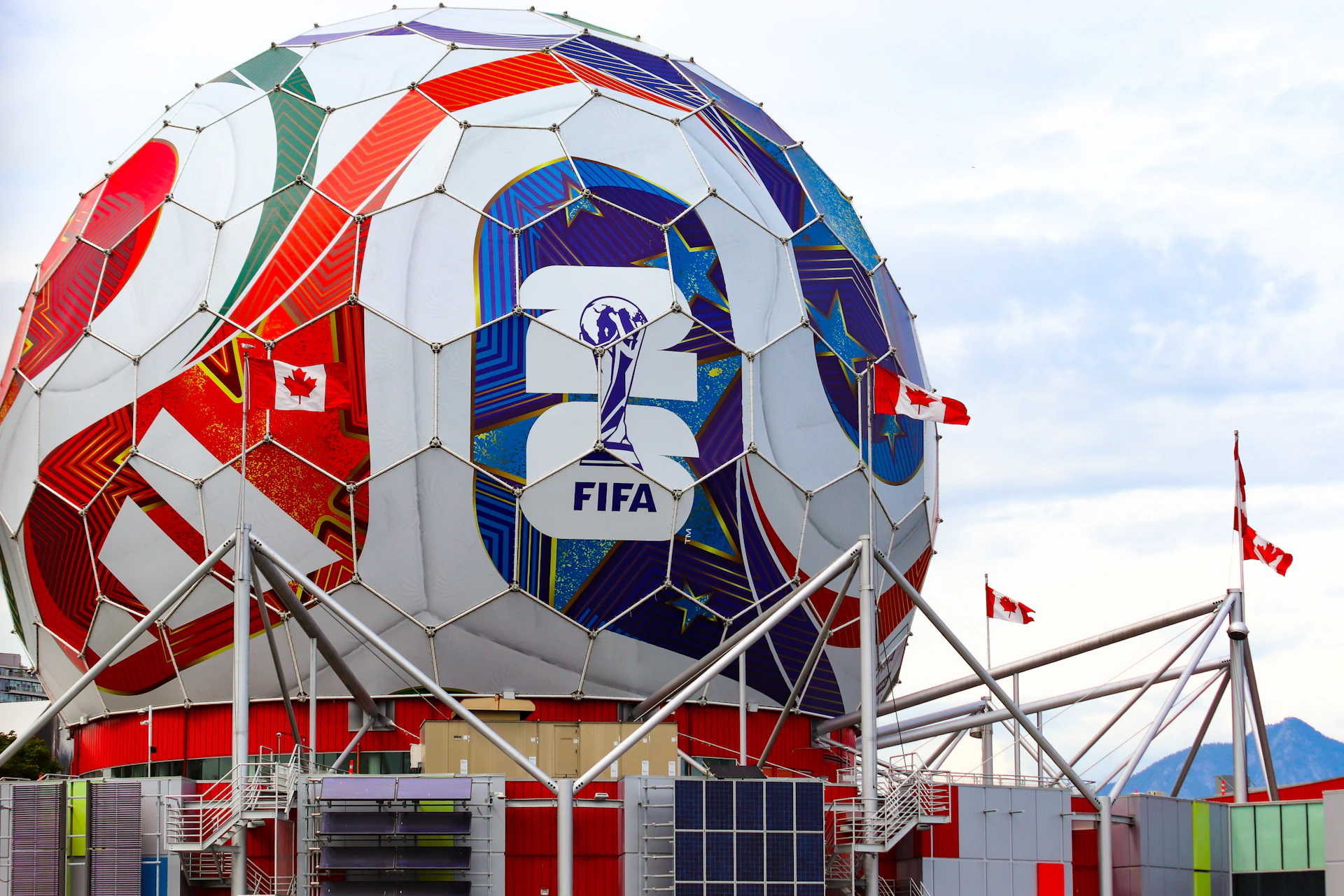A giant colorful fifa soccer ball structure with canadian flags.