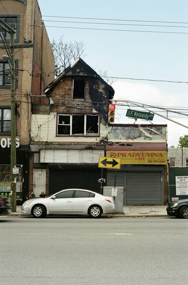 Fire-damaged commercial building with closed storefronts