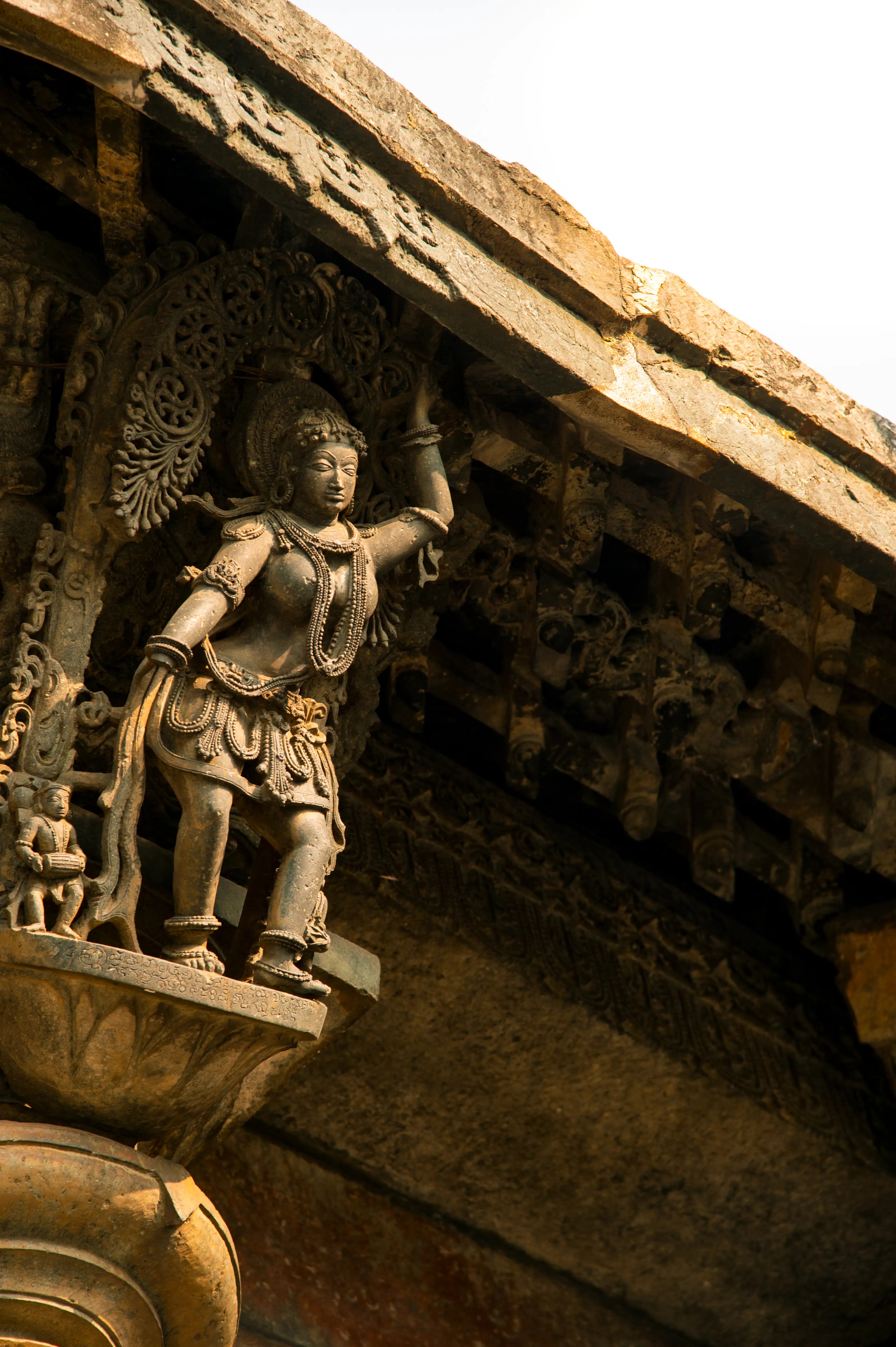 A celestial dancer sculpted in stone on a Hoysala-style temple