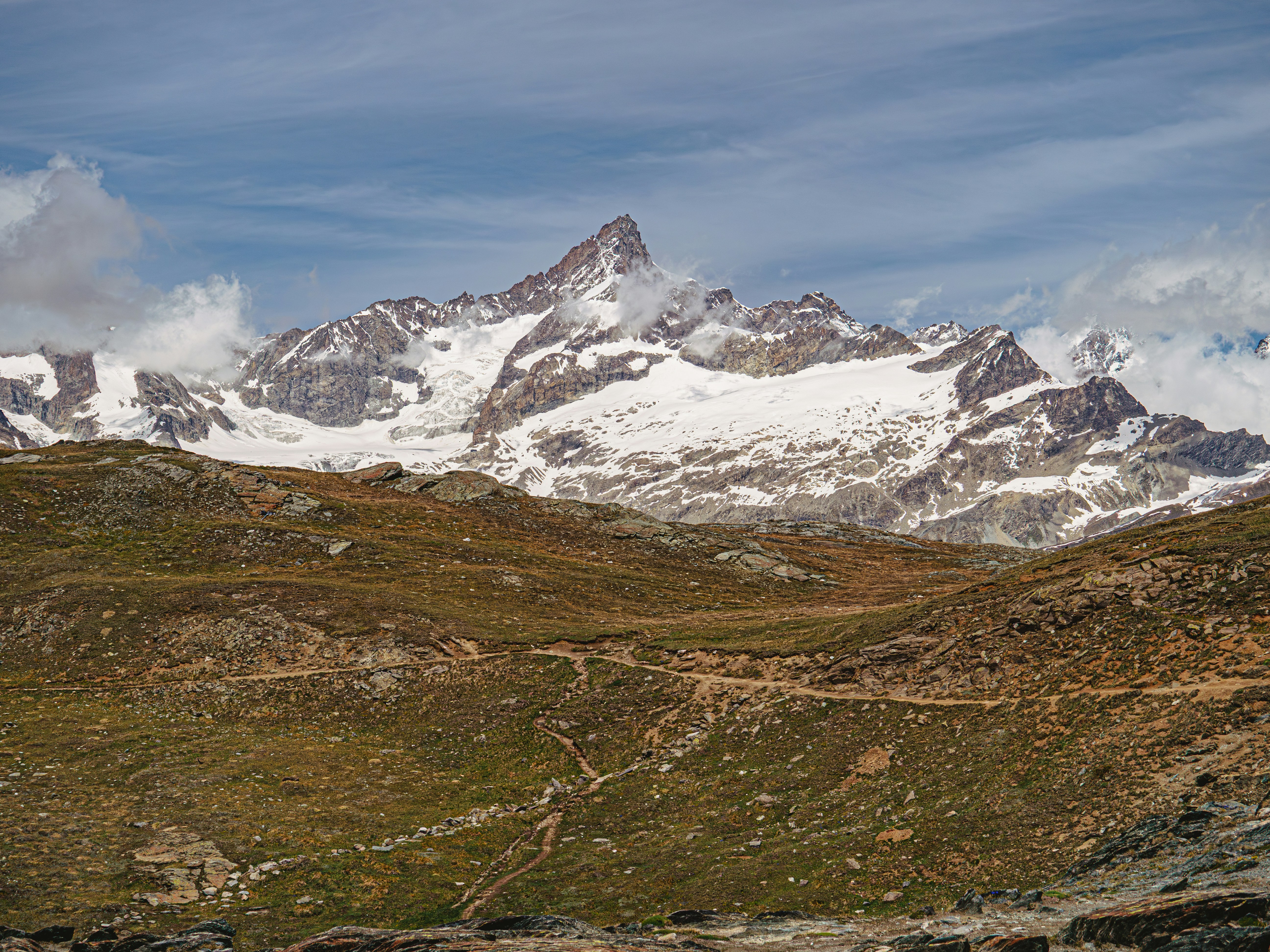 A high, rocky trail below the snow-capped Matterhorn on the glacier route above Zermatt