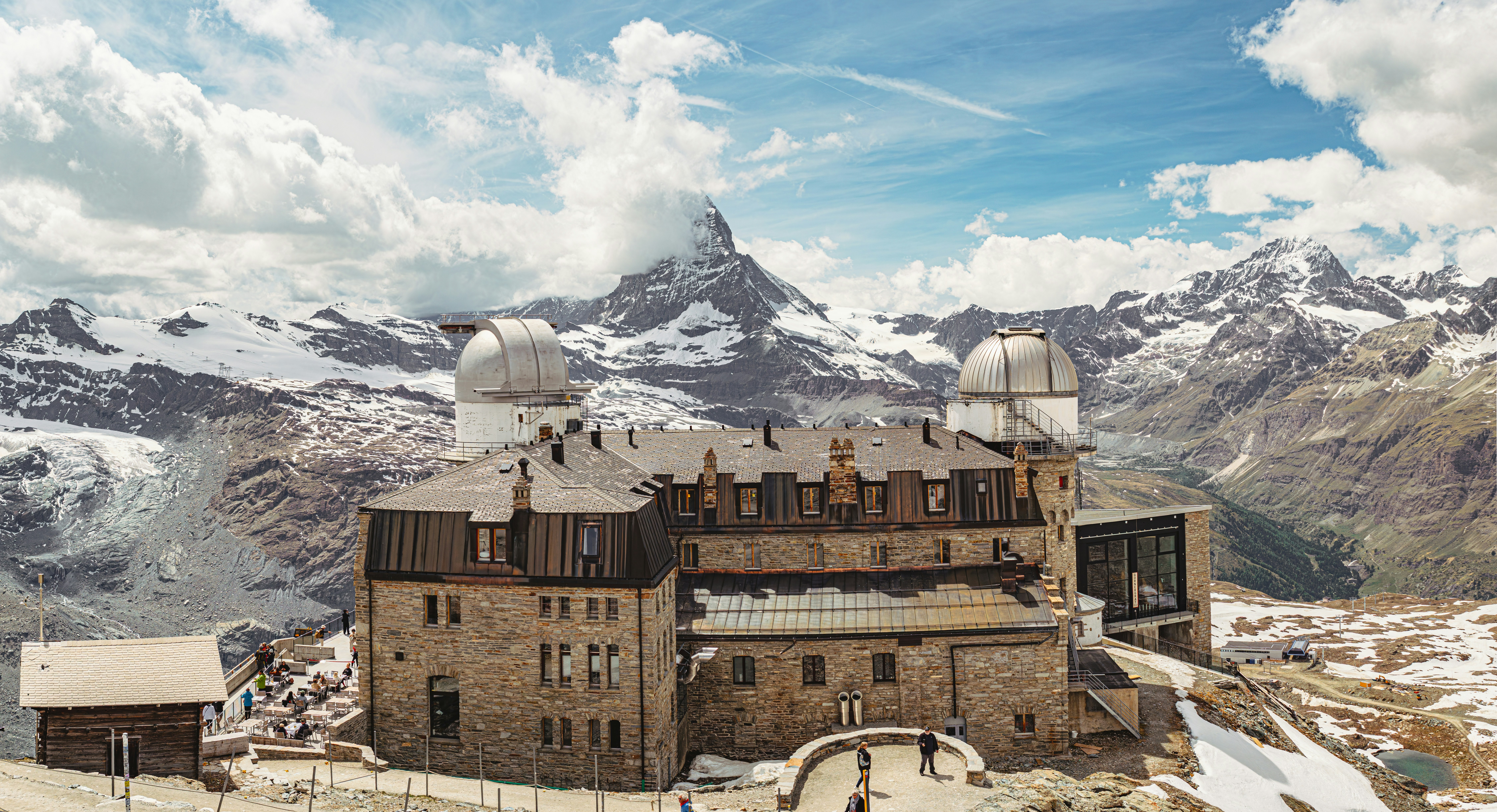 A mountain hotel and restaurant high above Zermatt with the Matterhorn peak beyond