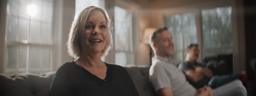 family sitting together in living room discussing difficult topic