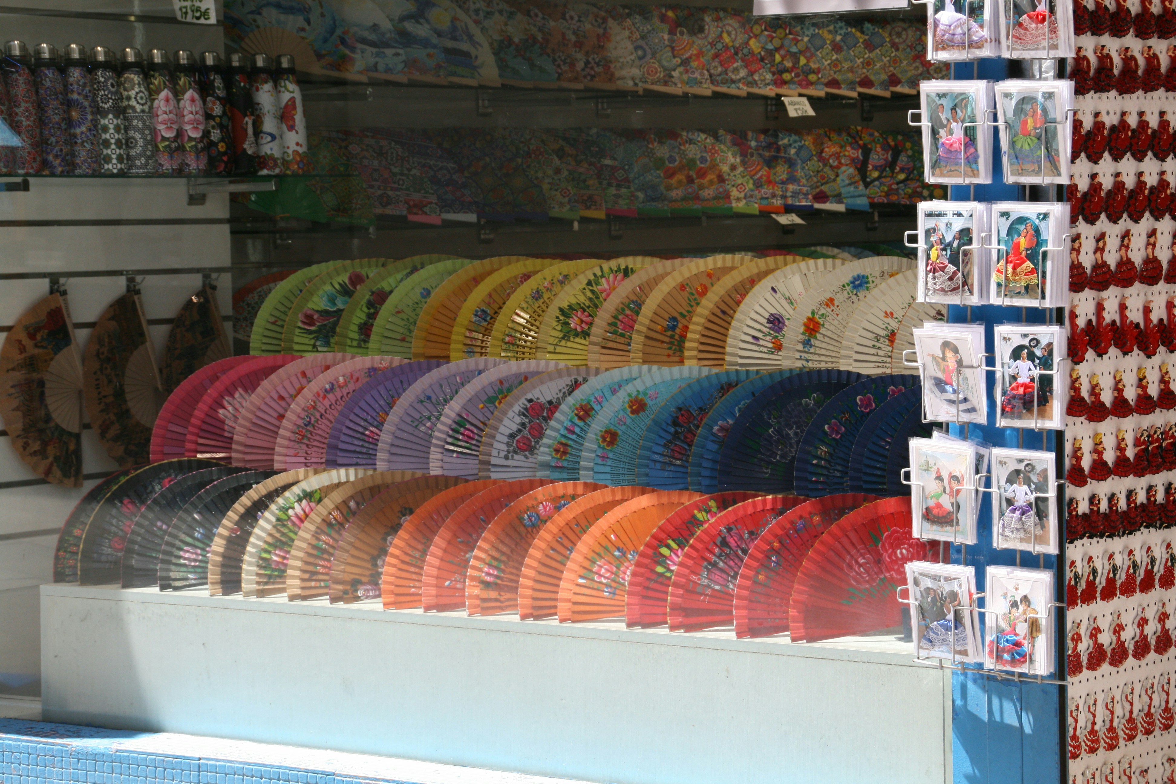 Colorful hand fans displayed in a shop.