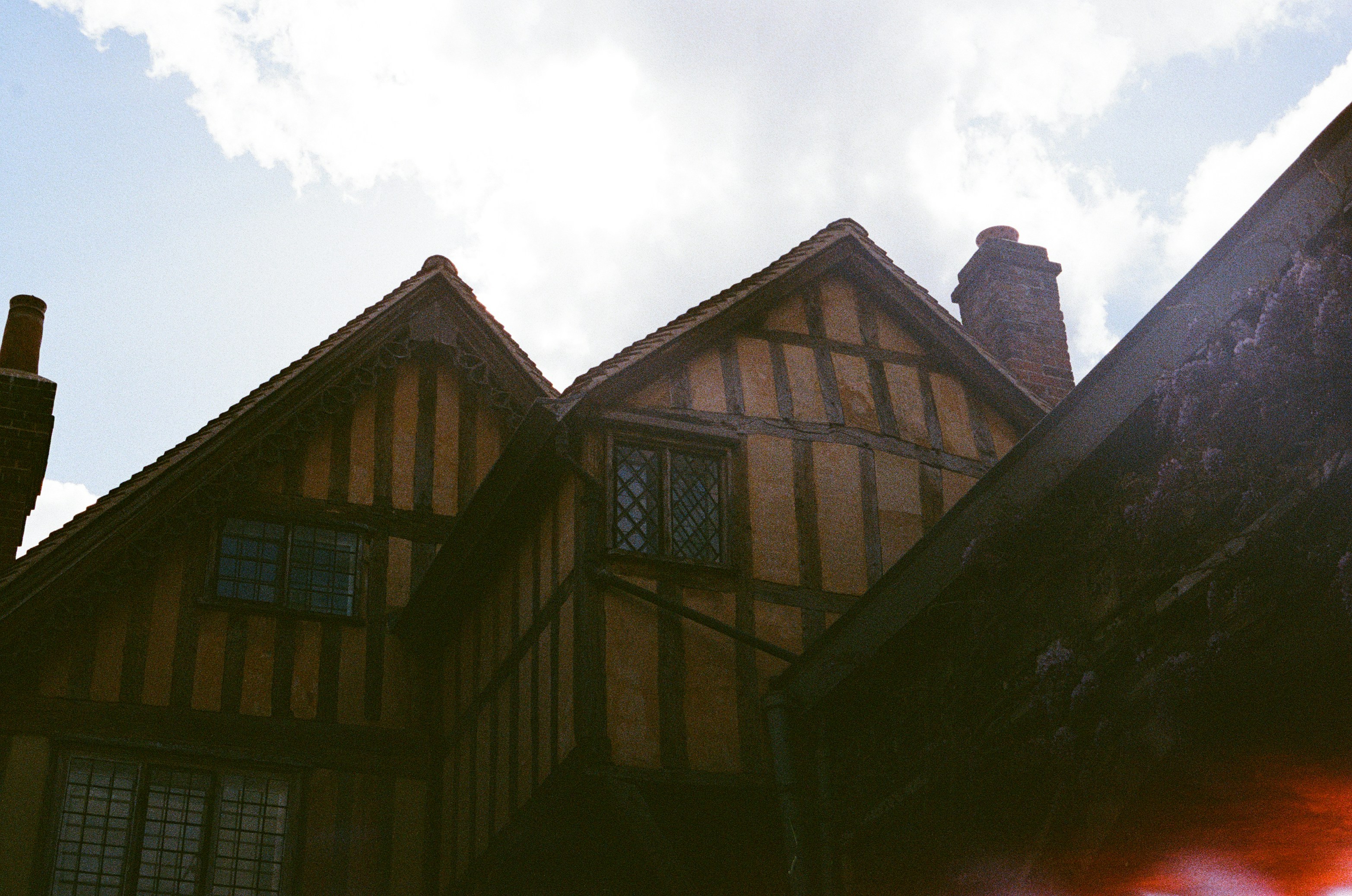 Winchester — Old timber-framed buildings with gabled roofs under a cloudy sky