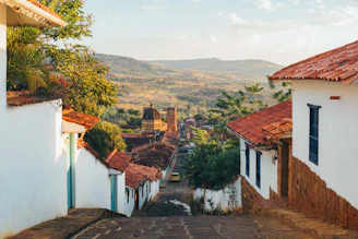 Hilly village street with white houses and red roofs