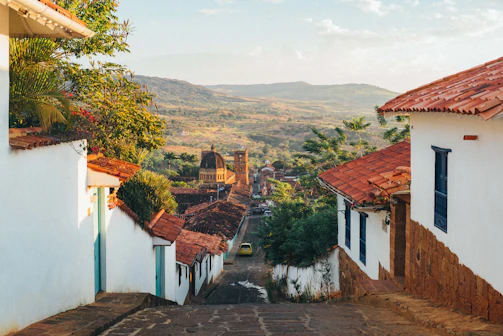 Hilly village street with white houses and red roofs