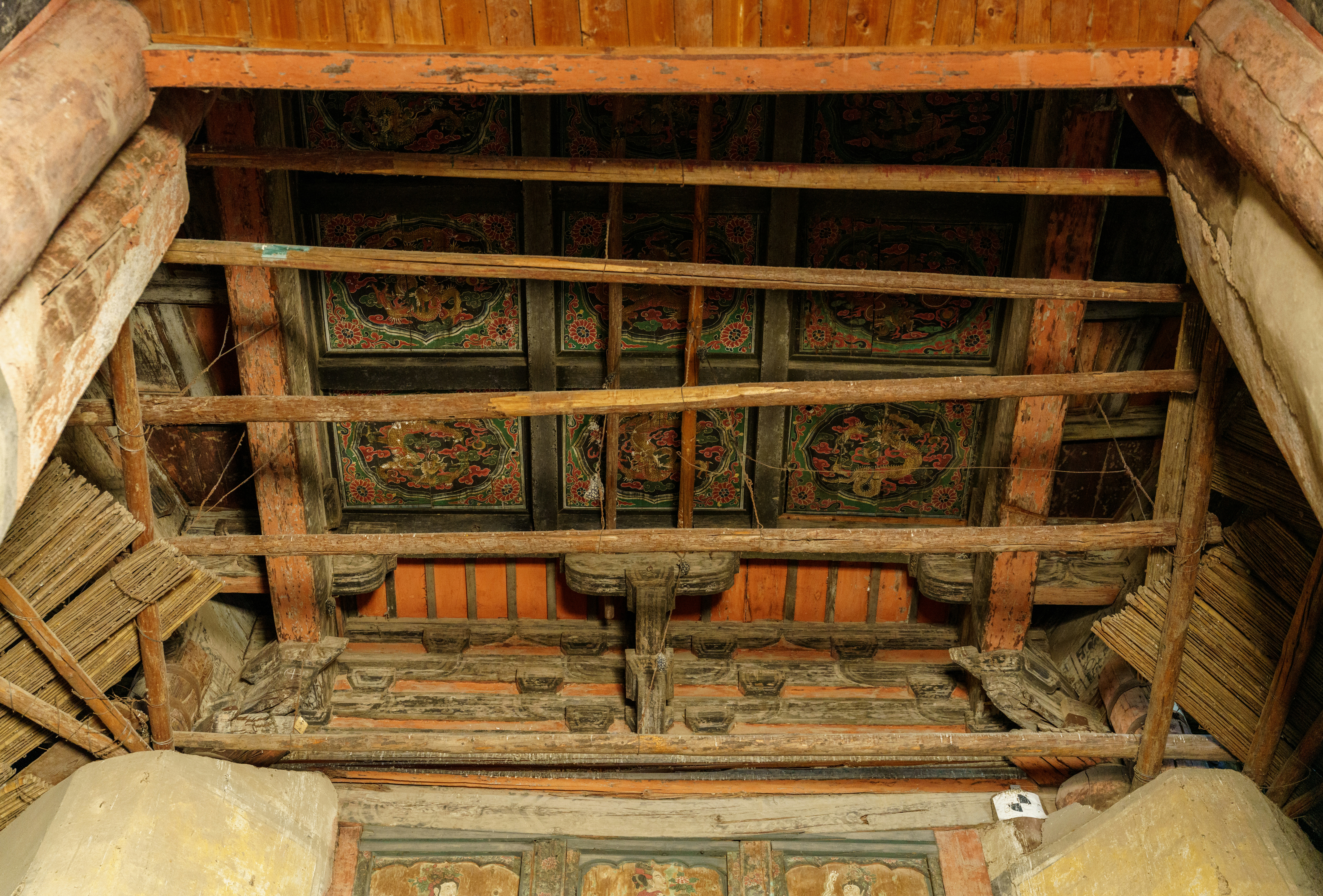 Ornate wooden ceiling with beams and decorative panels.