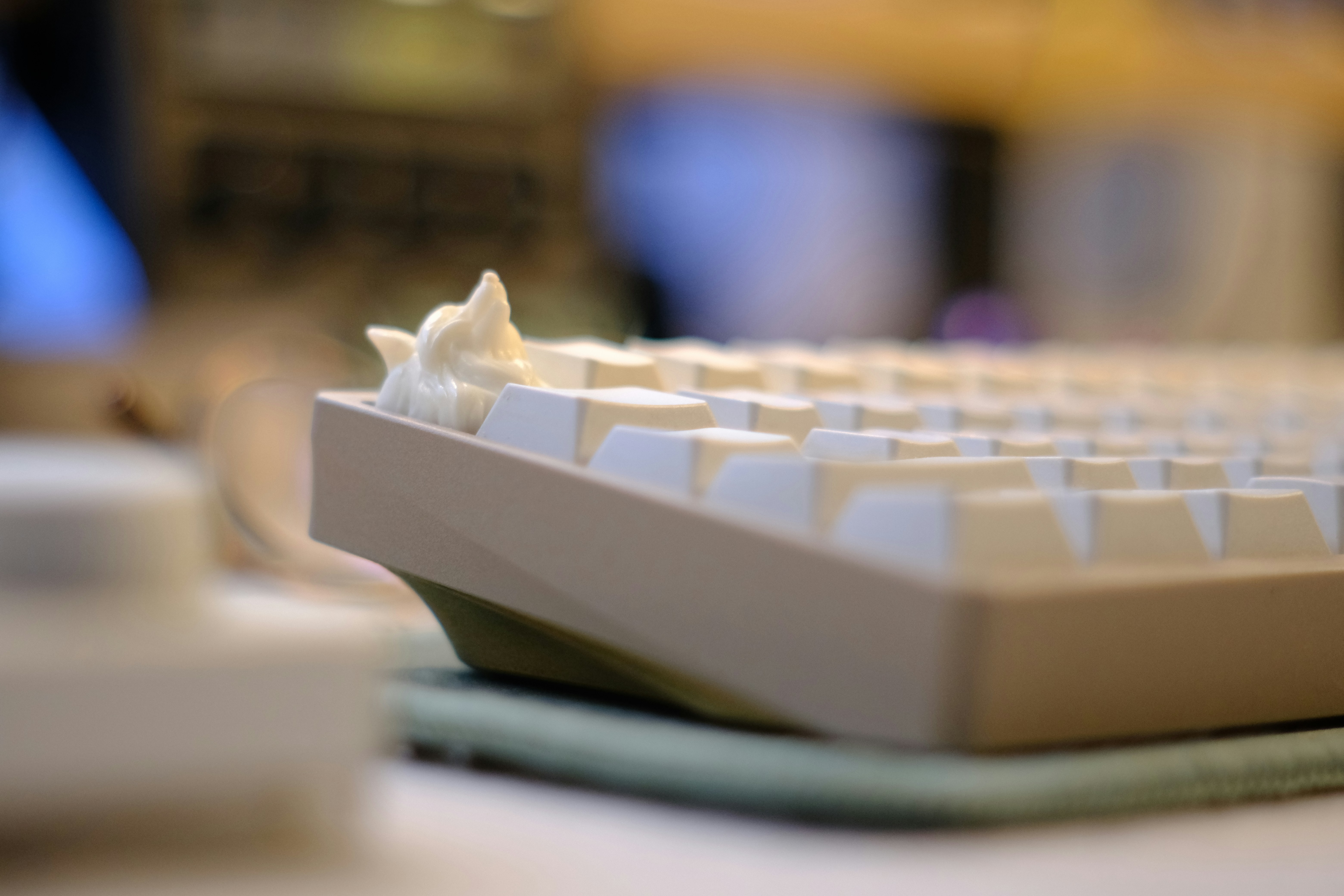 White mechanical keyboard with a unique cloud-like decoration.