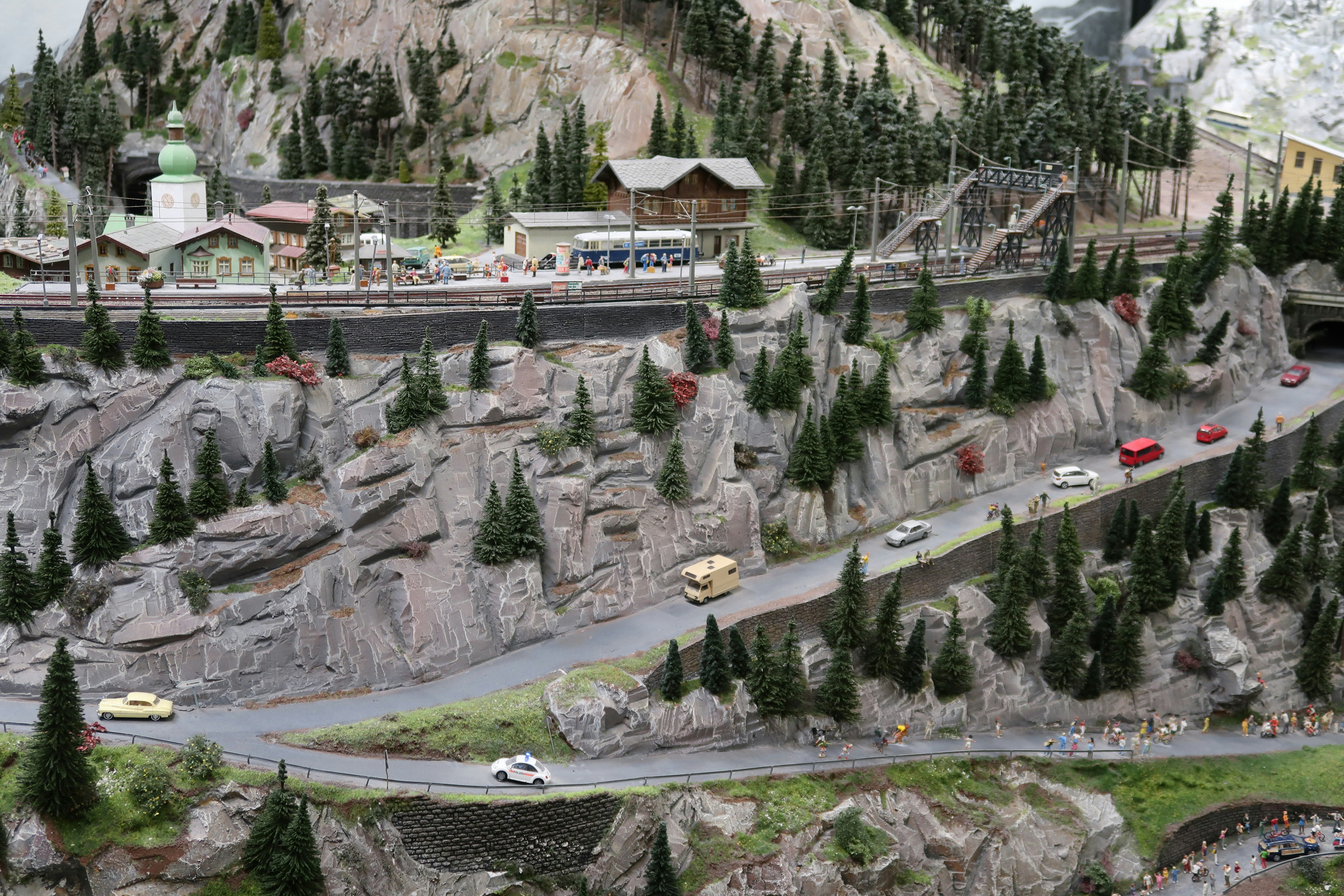 Miniature mountain landscape with winding roads and tiny cars