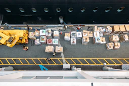 Overhead view of cargo being loaded onto a ship.