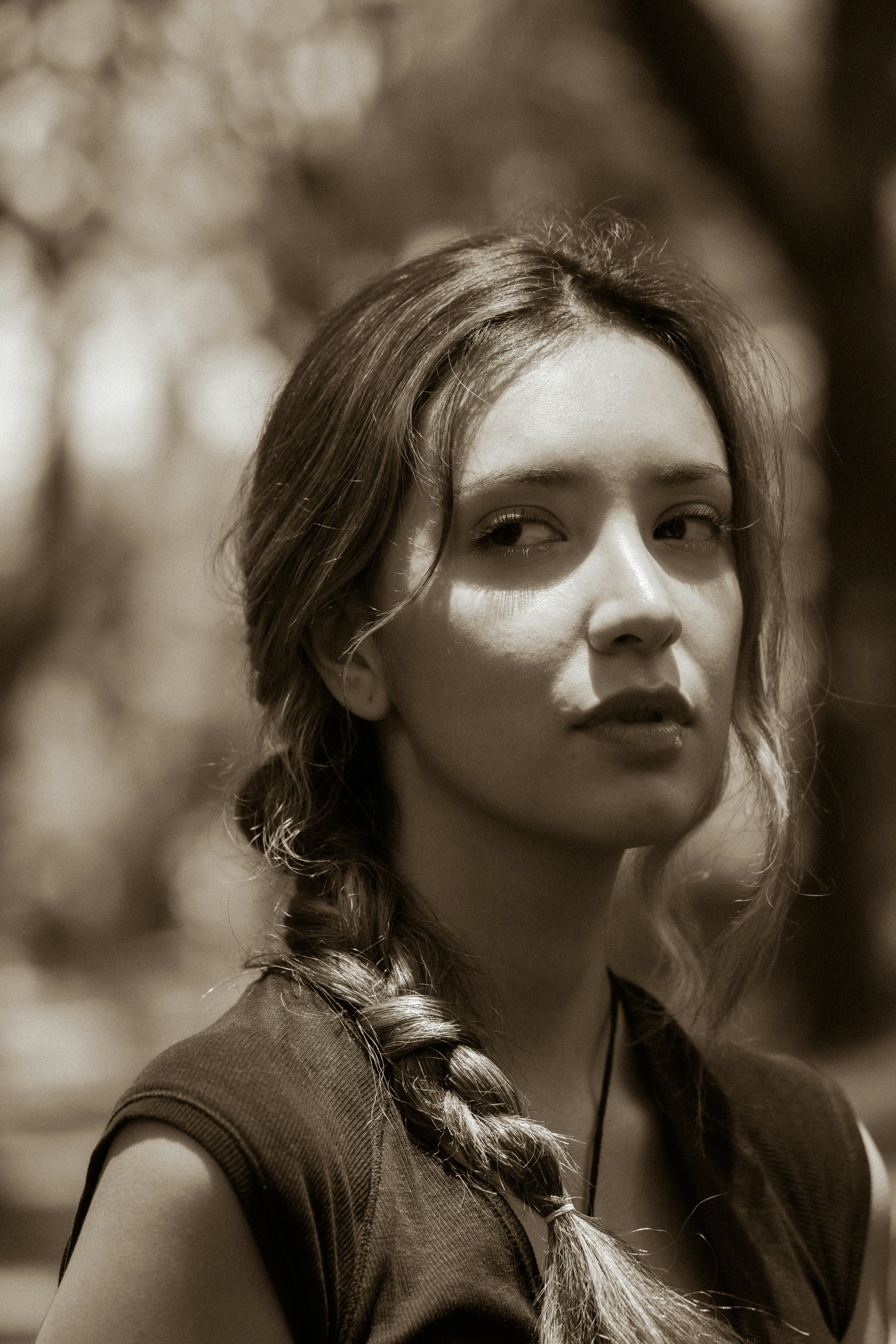 Young woman with a braid looking over her shoulder