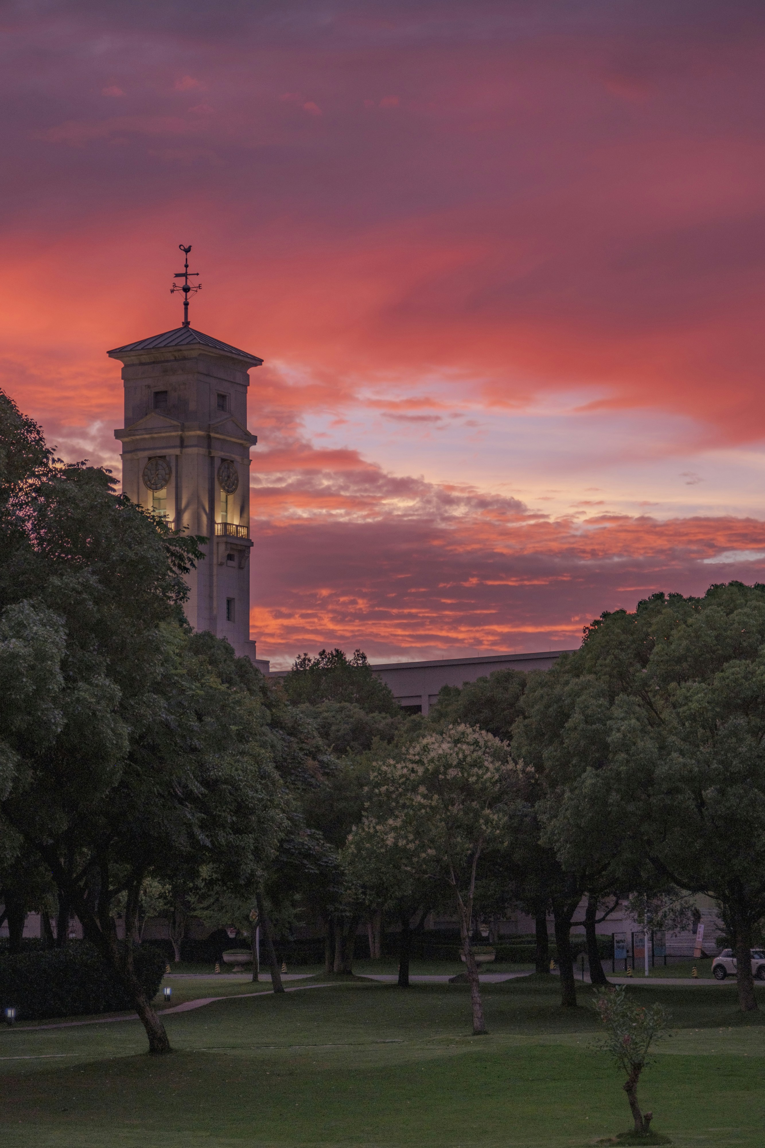 A tall tower stands against a vibrant red sunset sky.