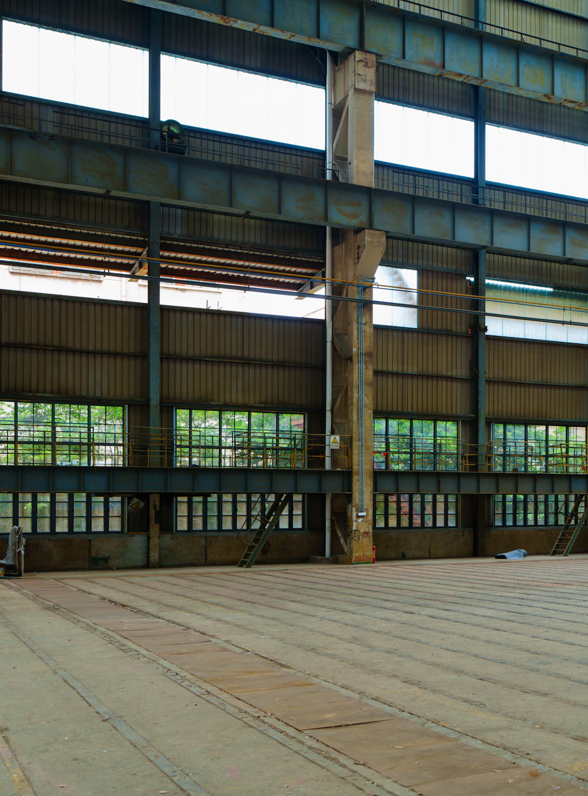 Large empty industrial warehouse with structural steel beams