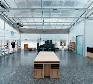 A large, bright workshop space with a wooden table.