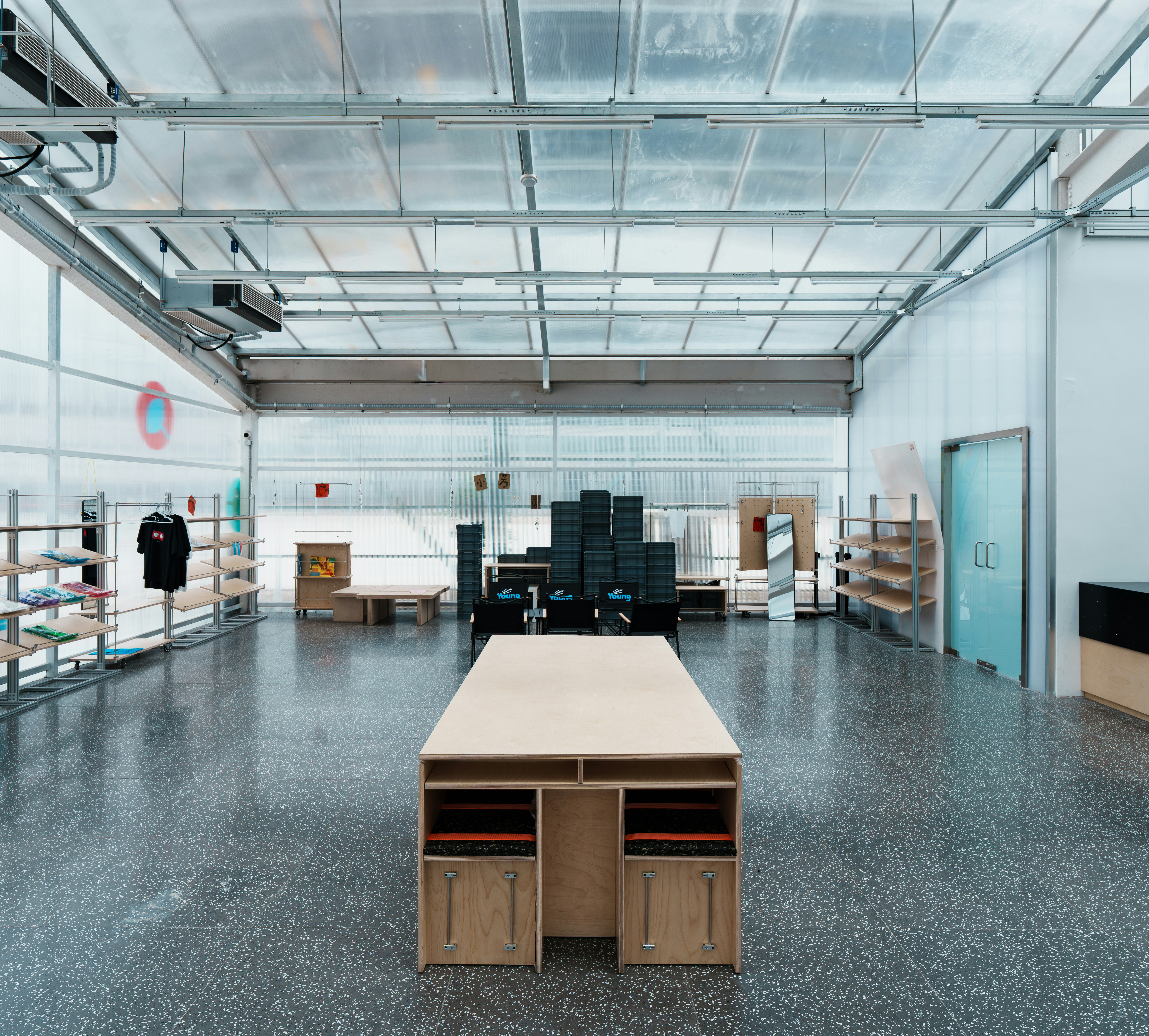 A large, bright workshop space with a wooden table.