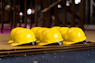 Several bright yellow hard hats are neatly lined up.