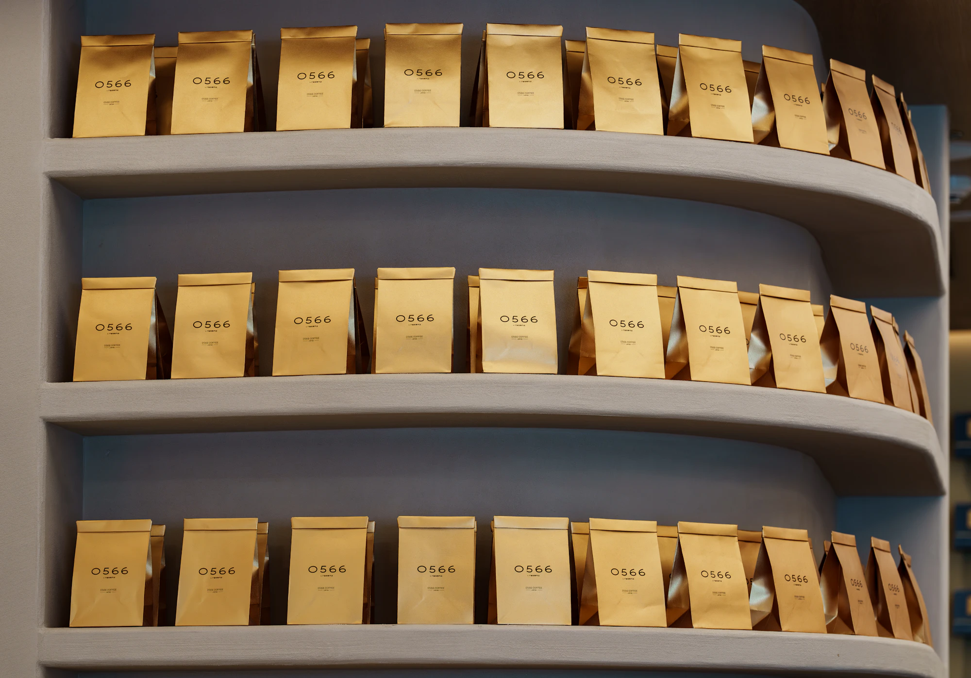 Rows of numbered coffee editions displayed neatly on curved shelves