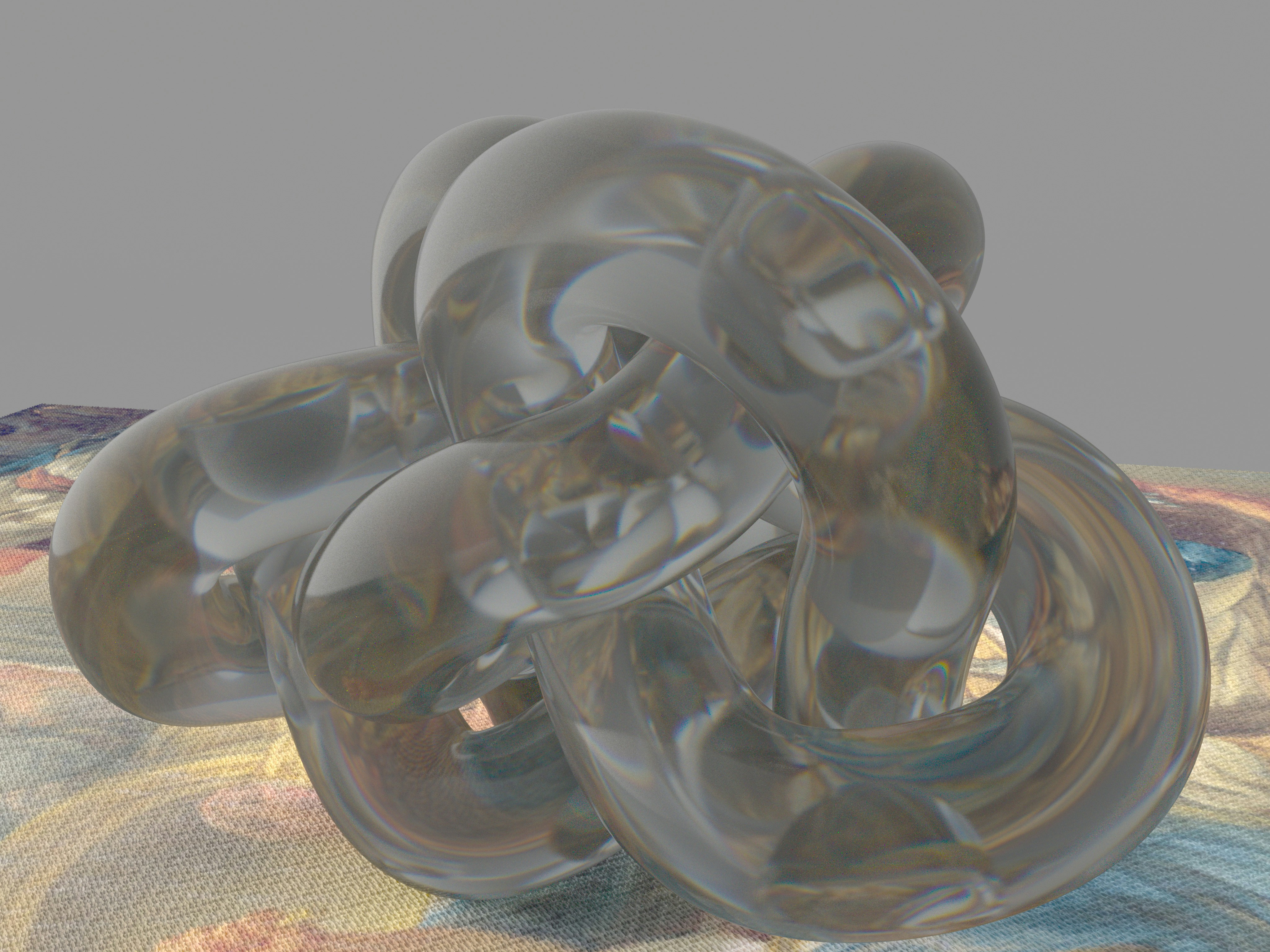 Transparent, intertwined abstract object on a colorful textured surface.