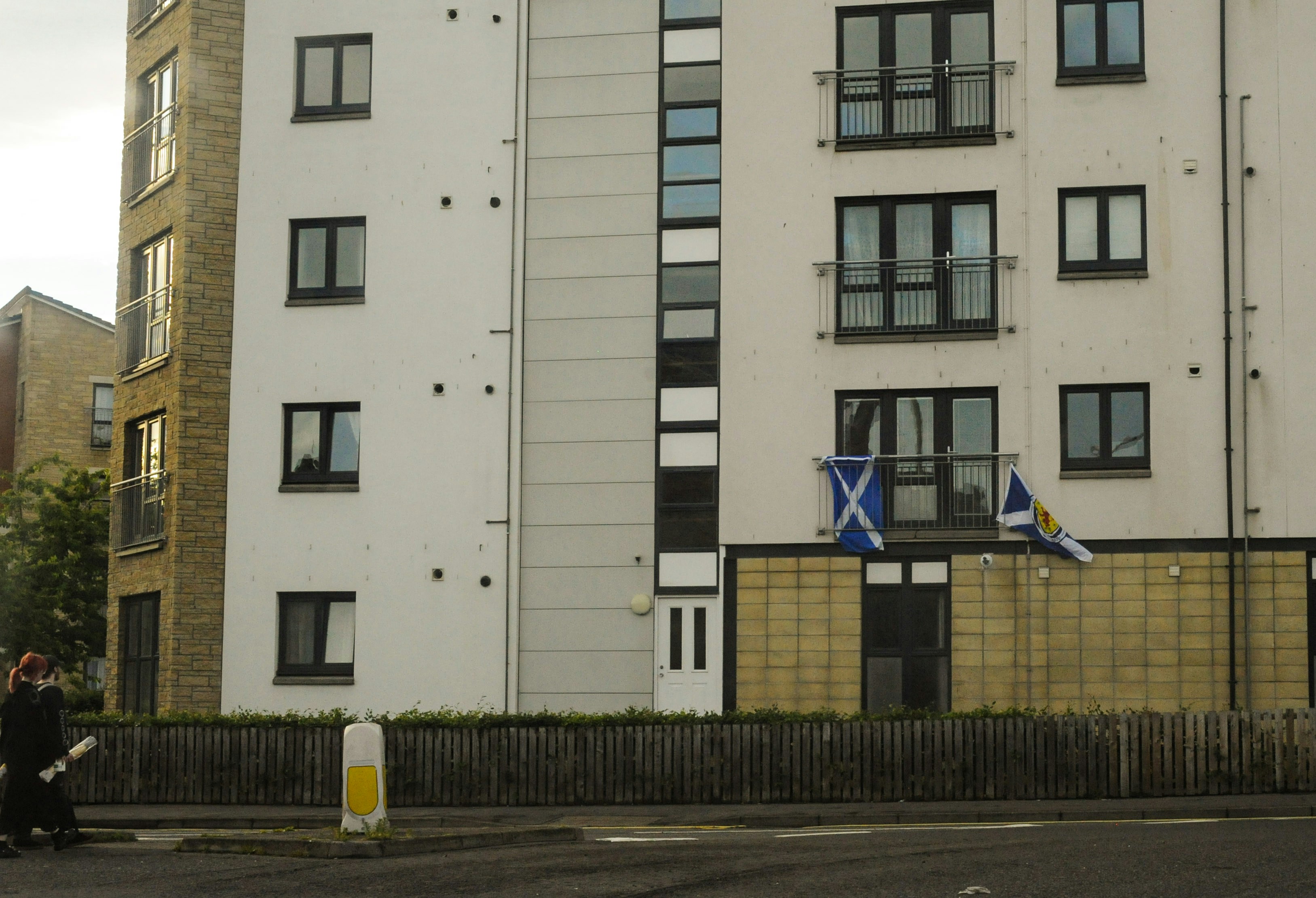 Modern apartment building with scottish flag on a balcony