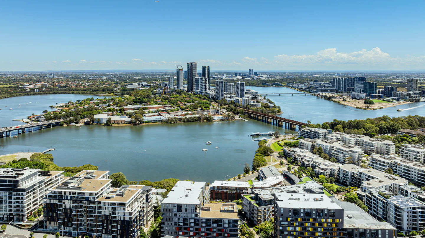 Aerial view of a city on the water, with bridges and parks