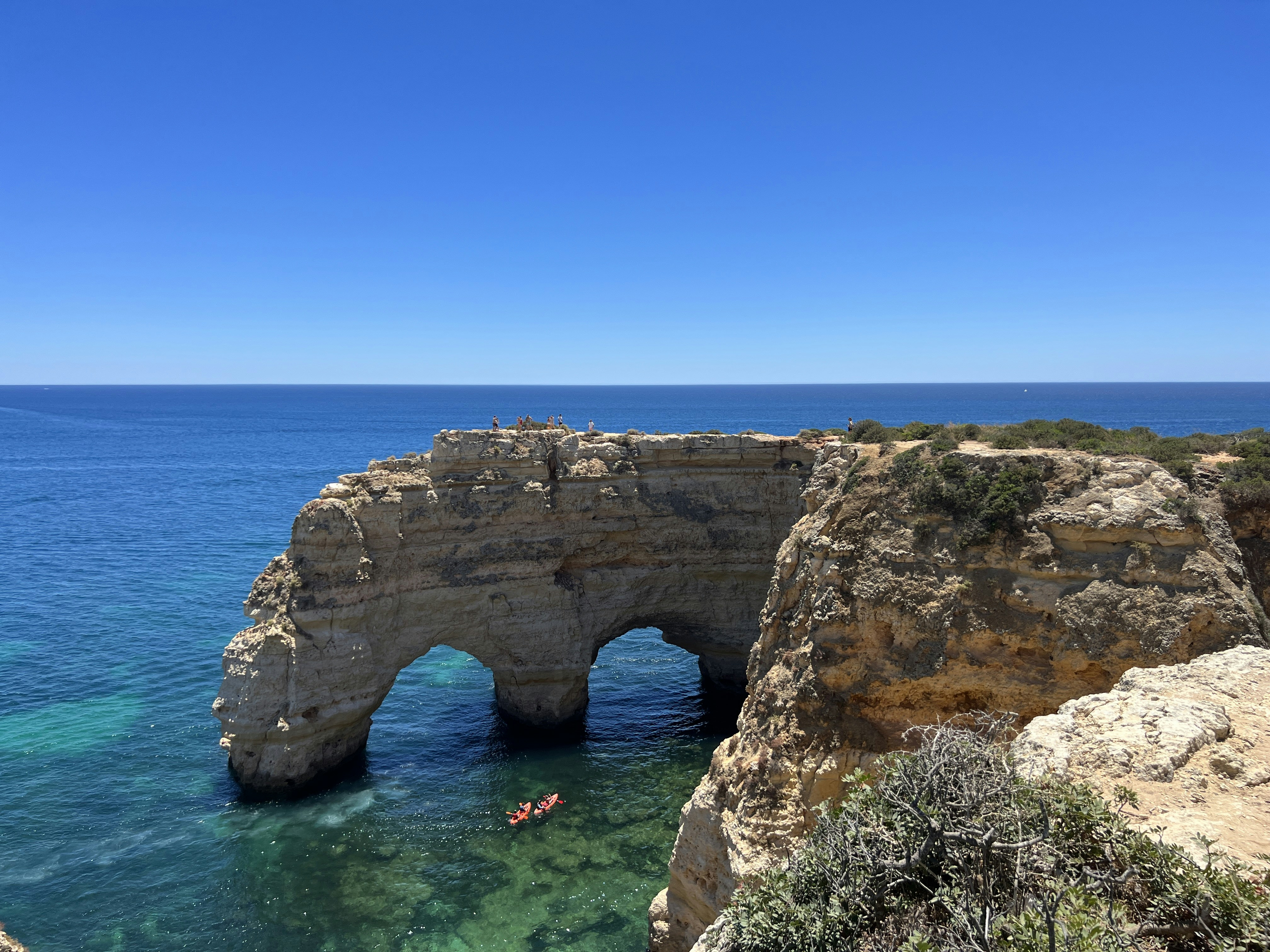 Coastal rock formation with natural arches in clear ocean