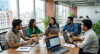 Five colleagues collaborating around a table in a modern office.