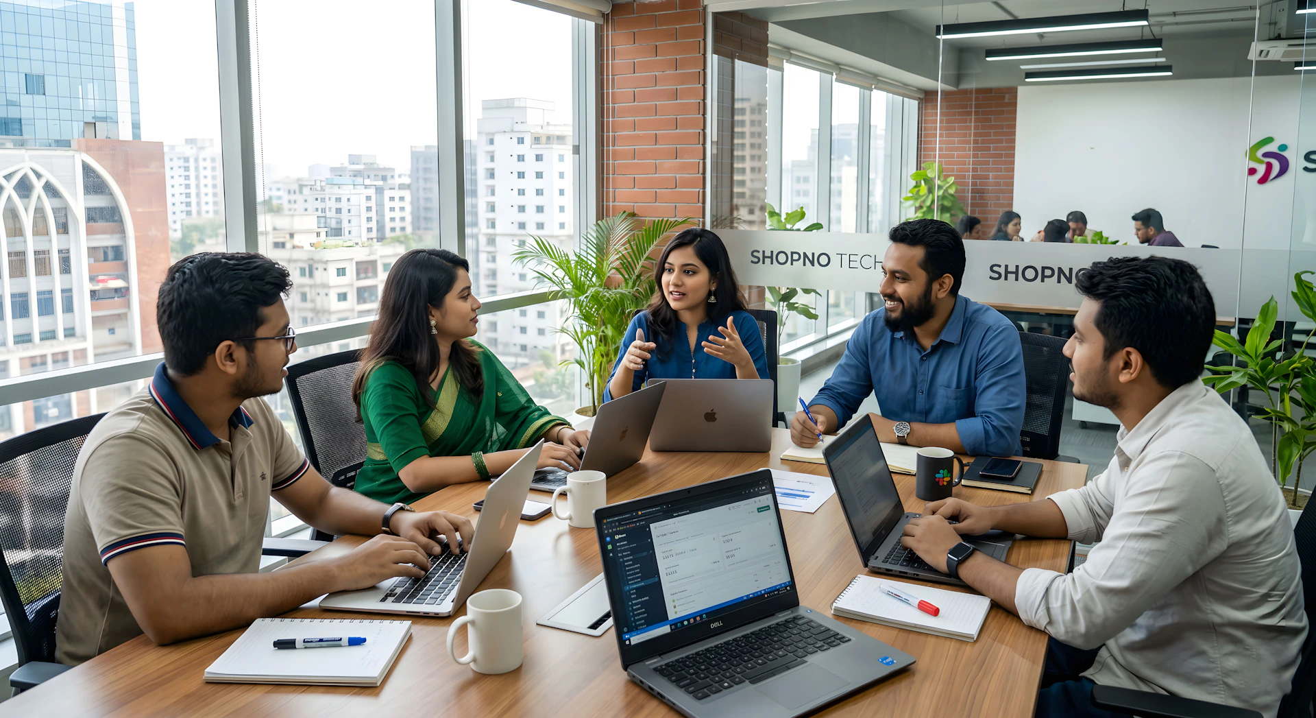 Five colleagues collaborating around a table in a modern office.