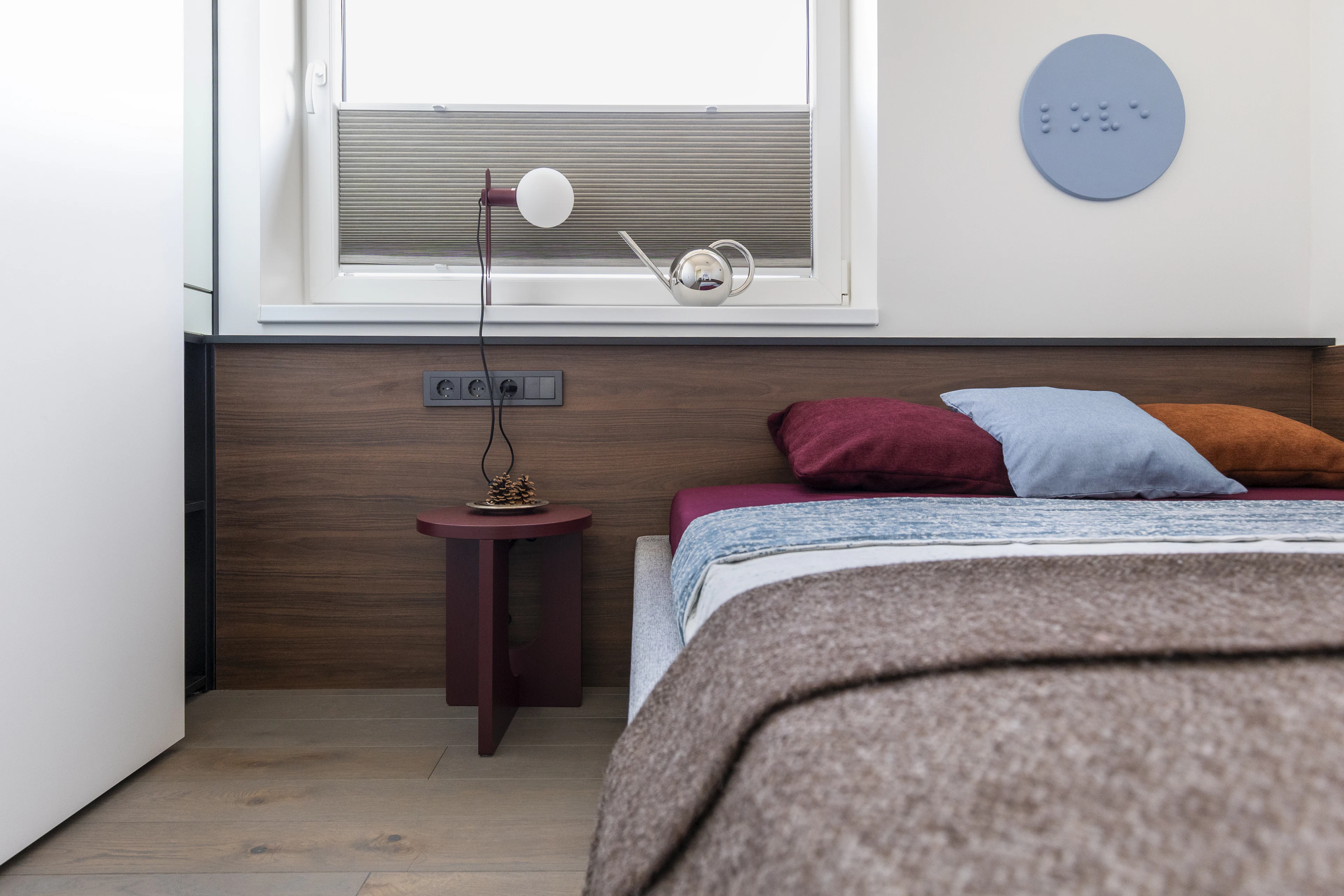 Bedroom with colourful bedding and a wooden headboard