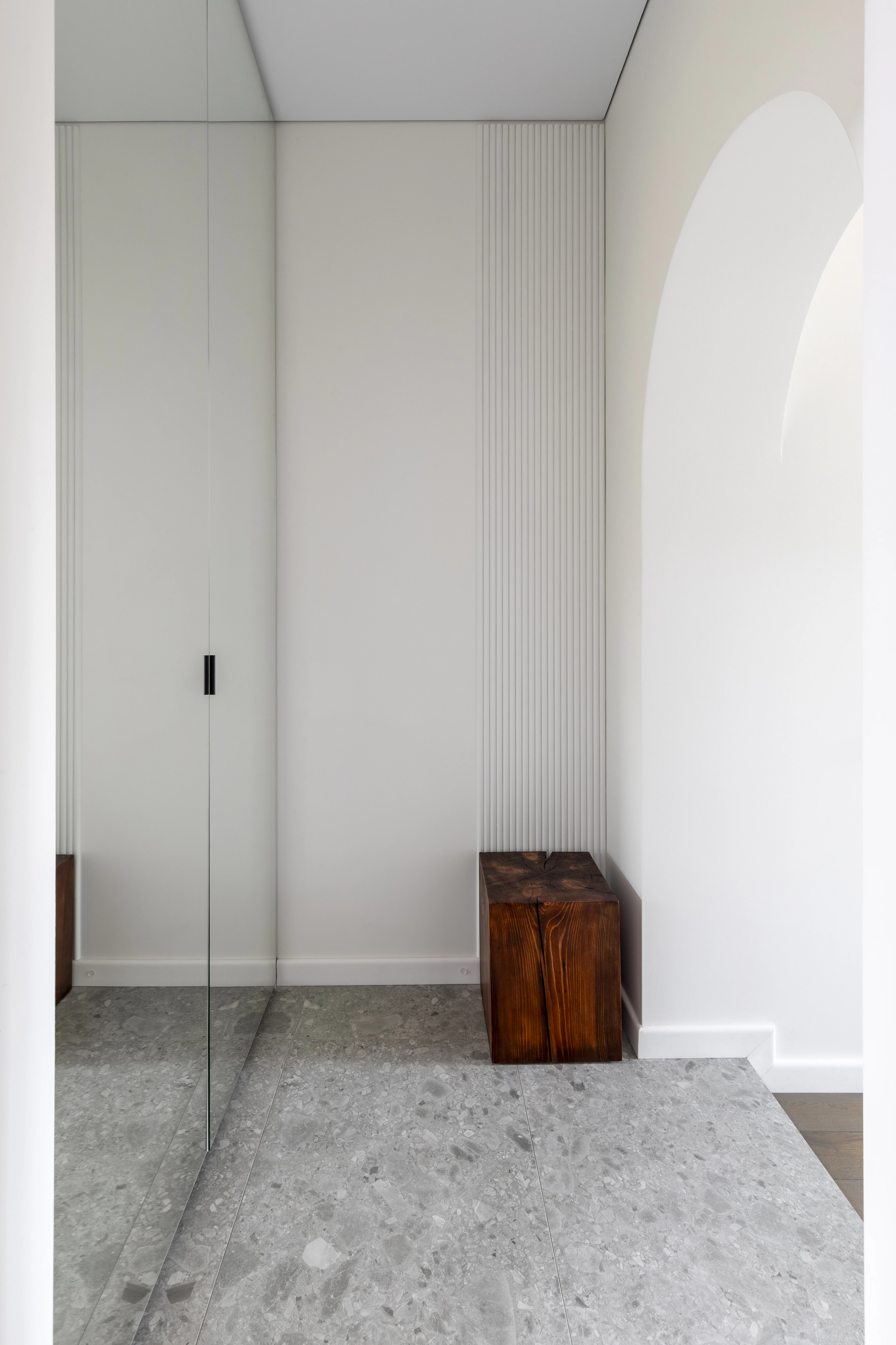 Hallway with a full-length mirror and wooden bench