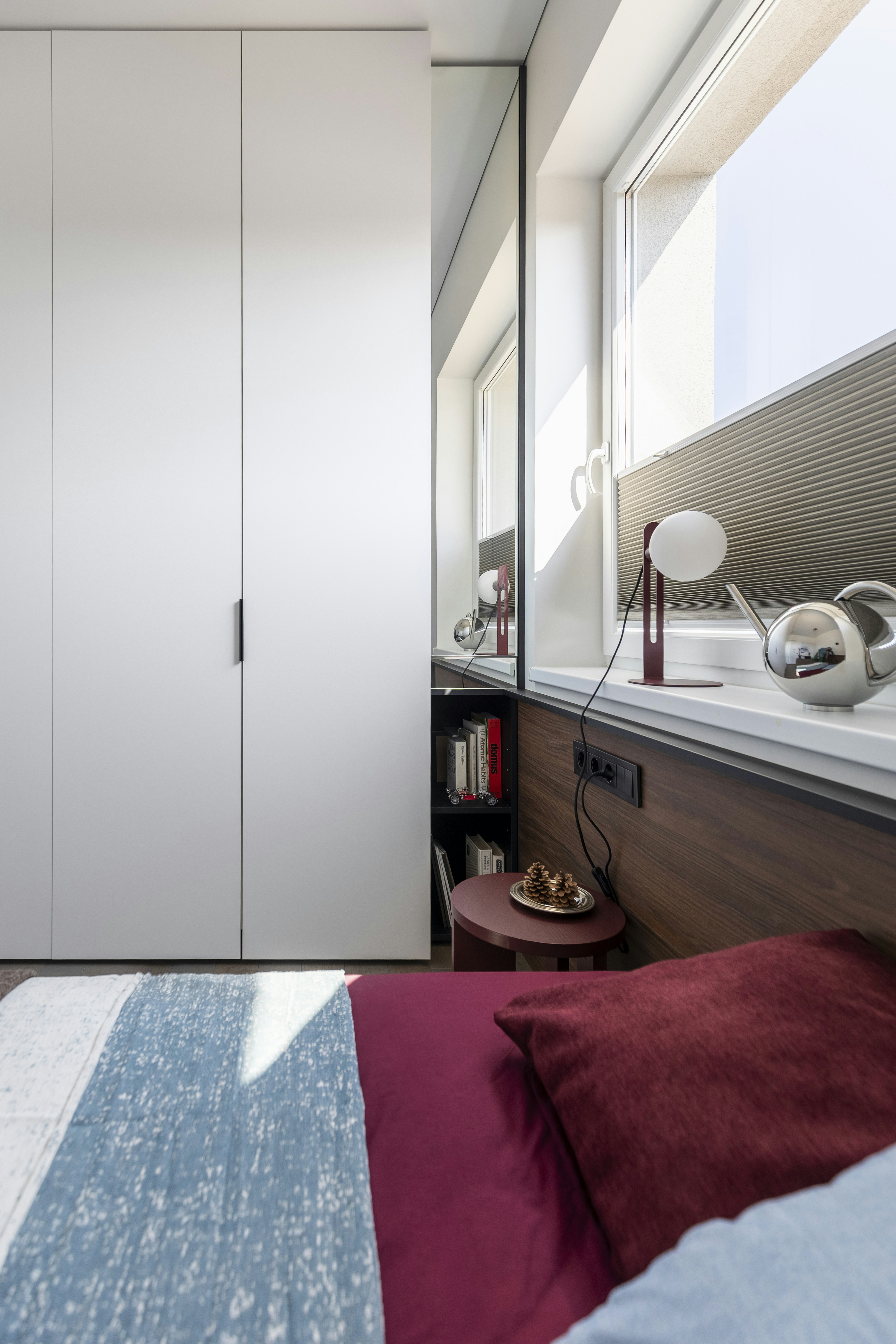 Tall bookshelf in a small bedroom