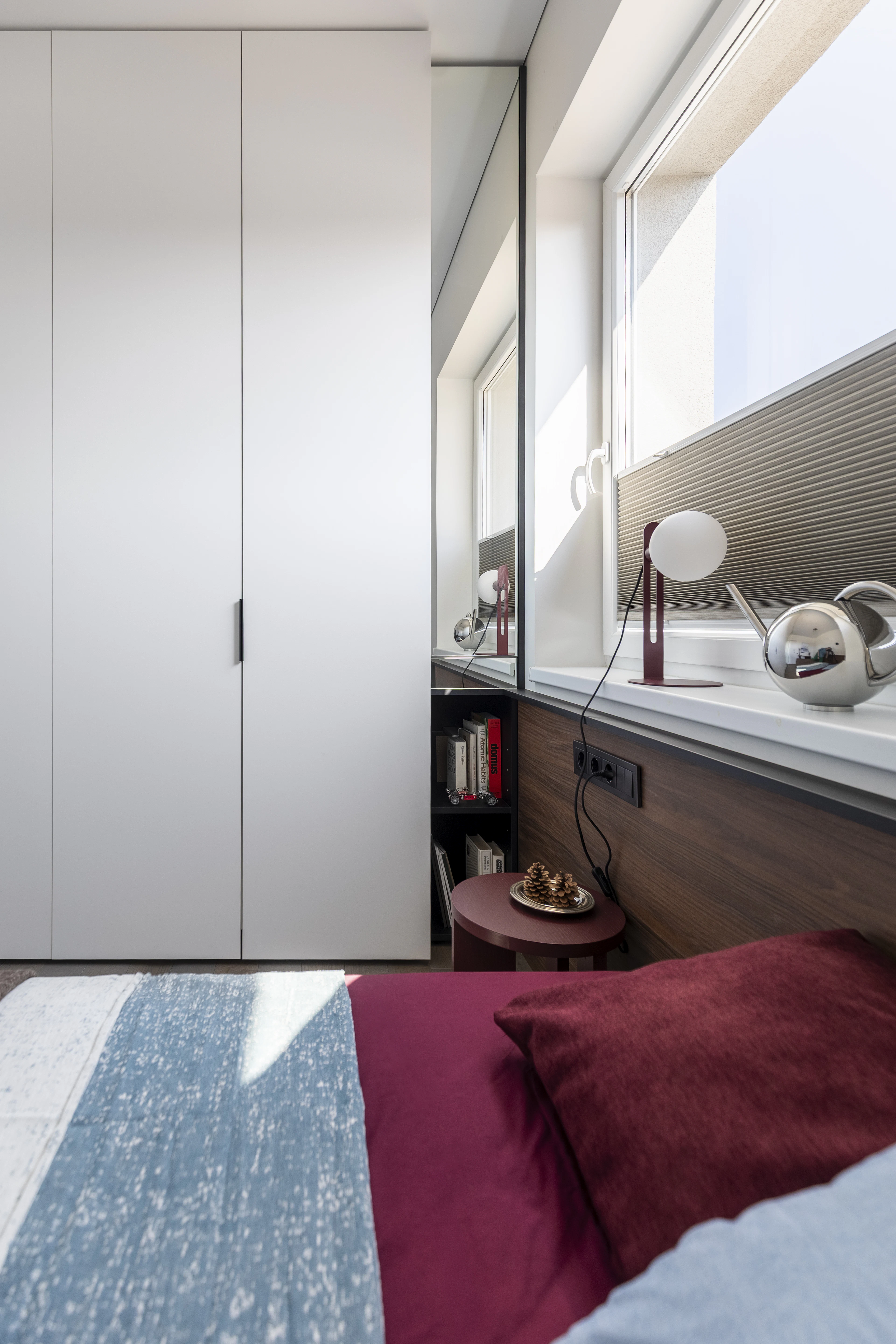 Bedroom with a white wardrobe and a window