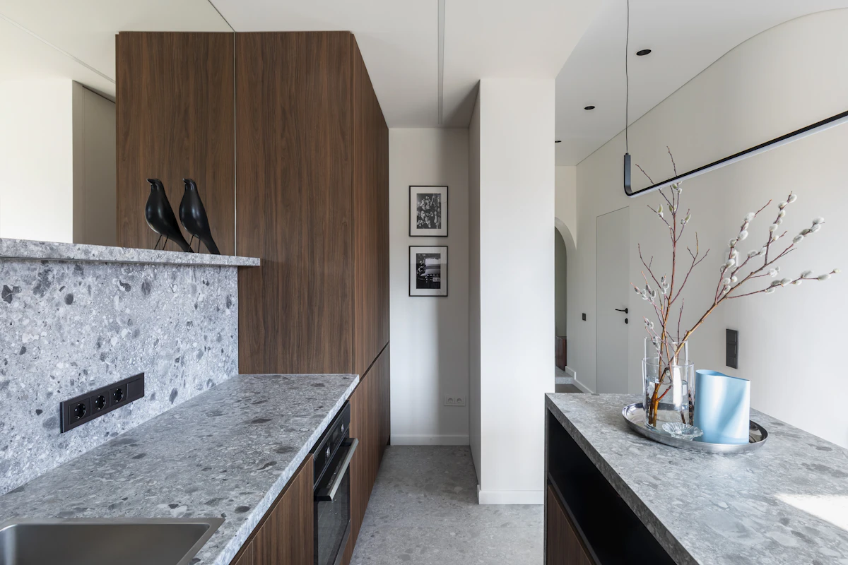 A narrow galley-style kitchen with counters on both sides, the kind of tight layout where a high chair's footprint matters most