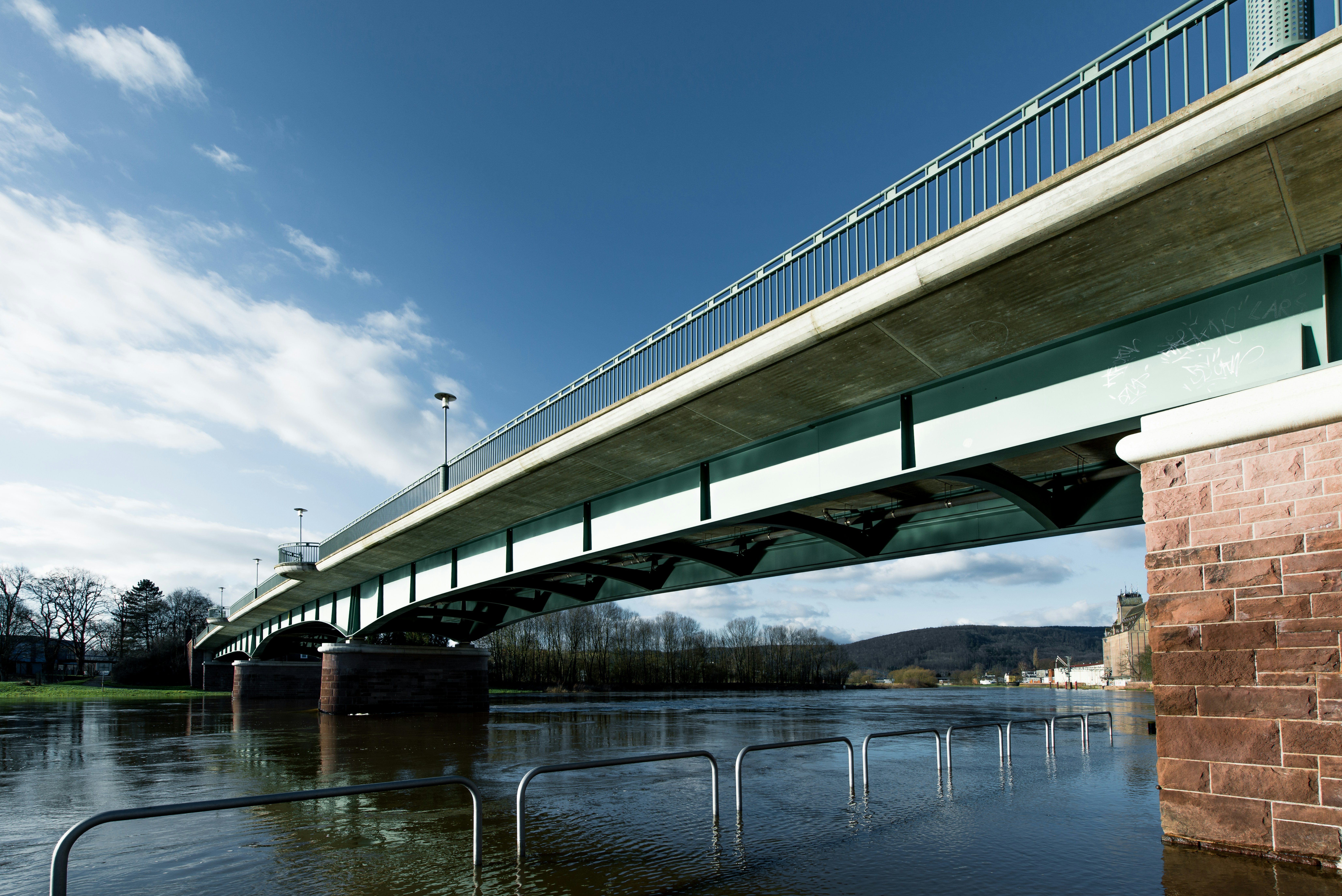 Bridge over a flooded river on a sunny day.
