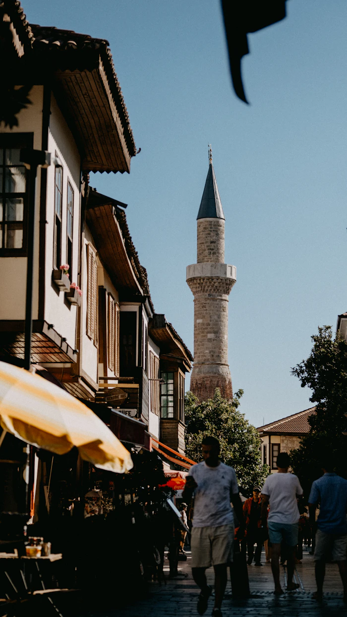 A minaret rising over a sunlit lane in Kaleiçi, Antalya's old town