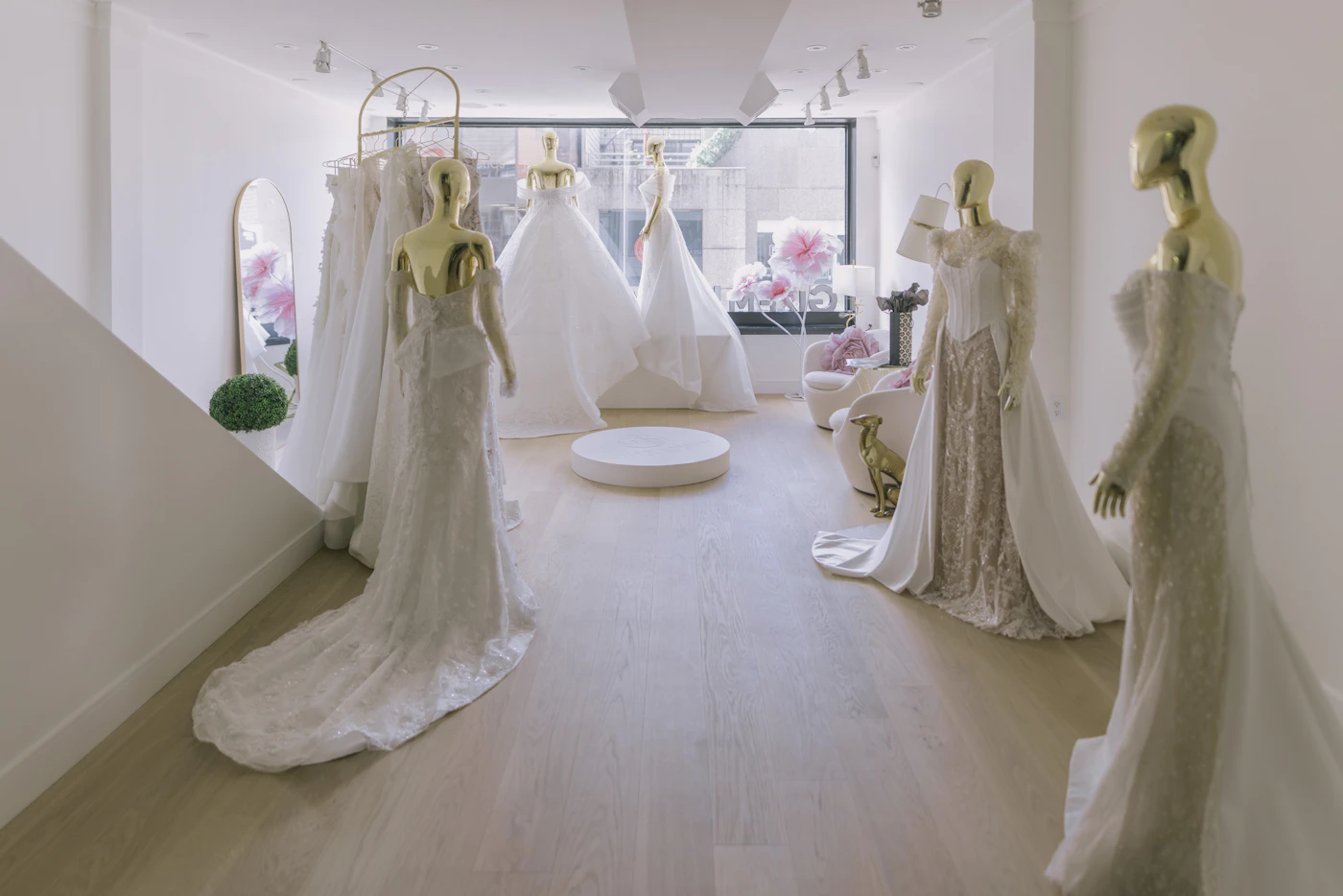 Inclusive size charts for bridal boutiques near me — Wedding dresses of various sizes hang on a rack.