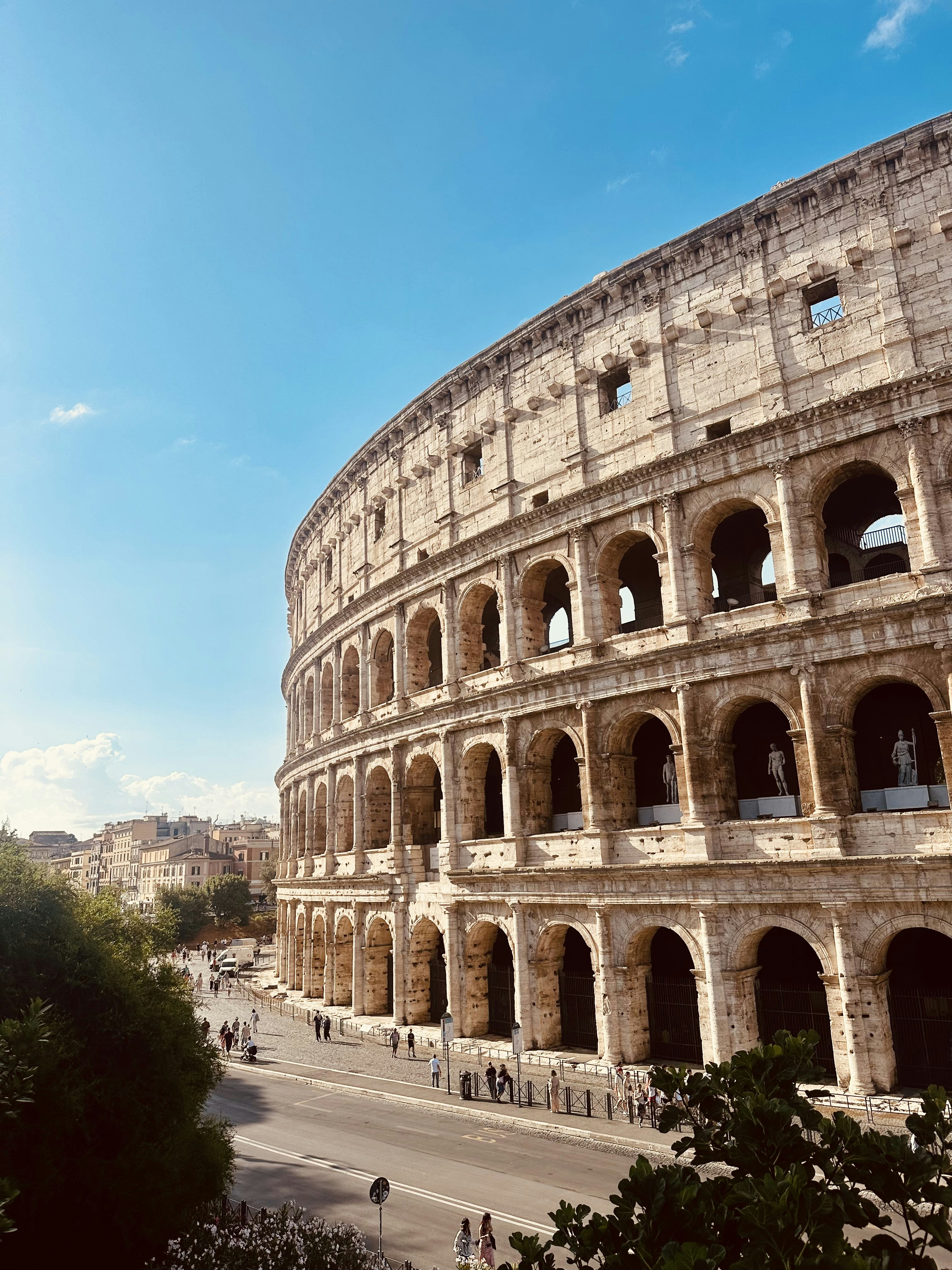 The majestic colosseum under a vibrant blue sky.