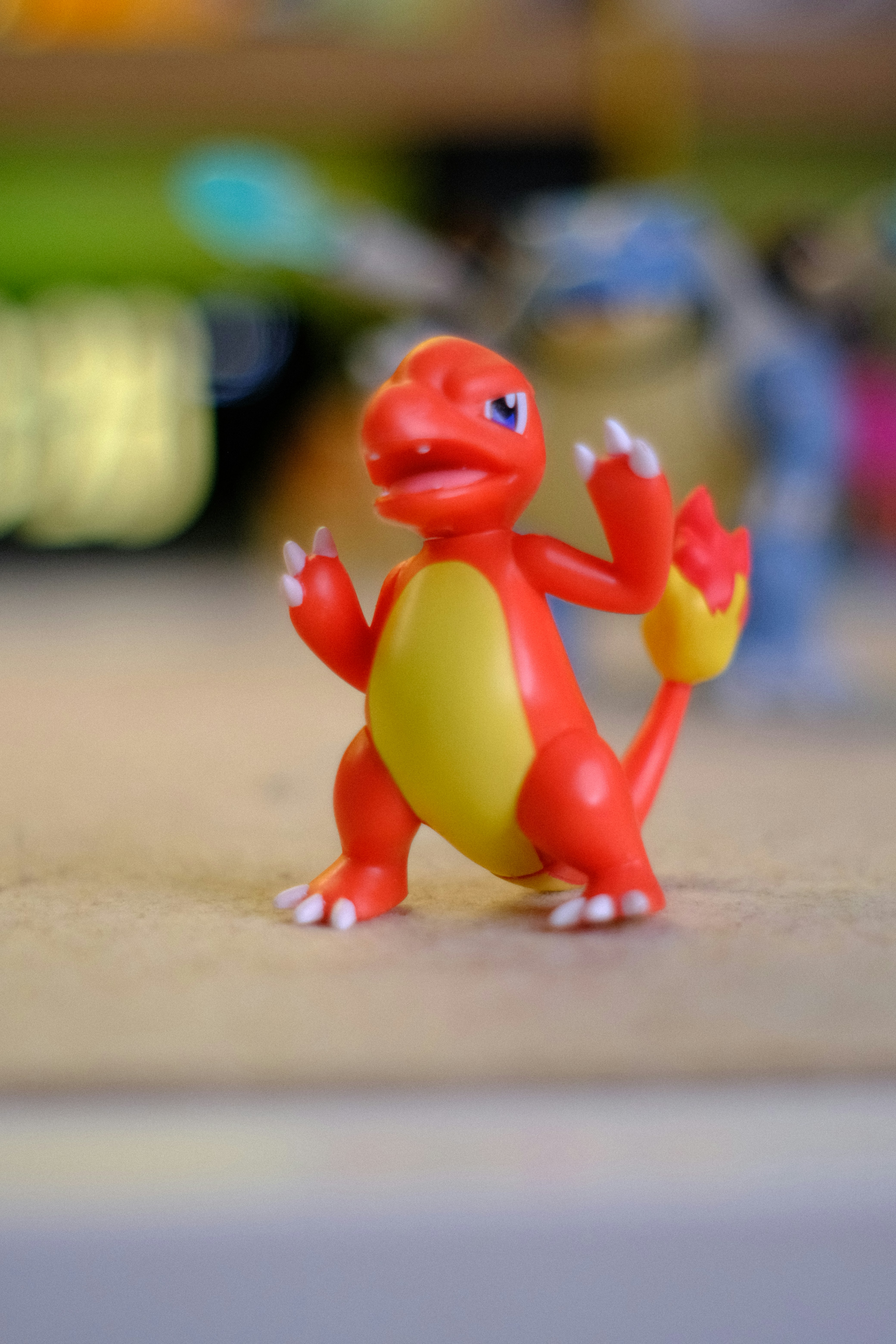 A red and yellow charmander toy stands on a surface